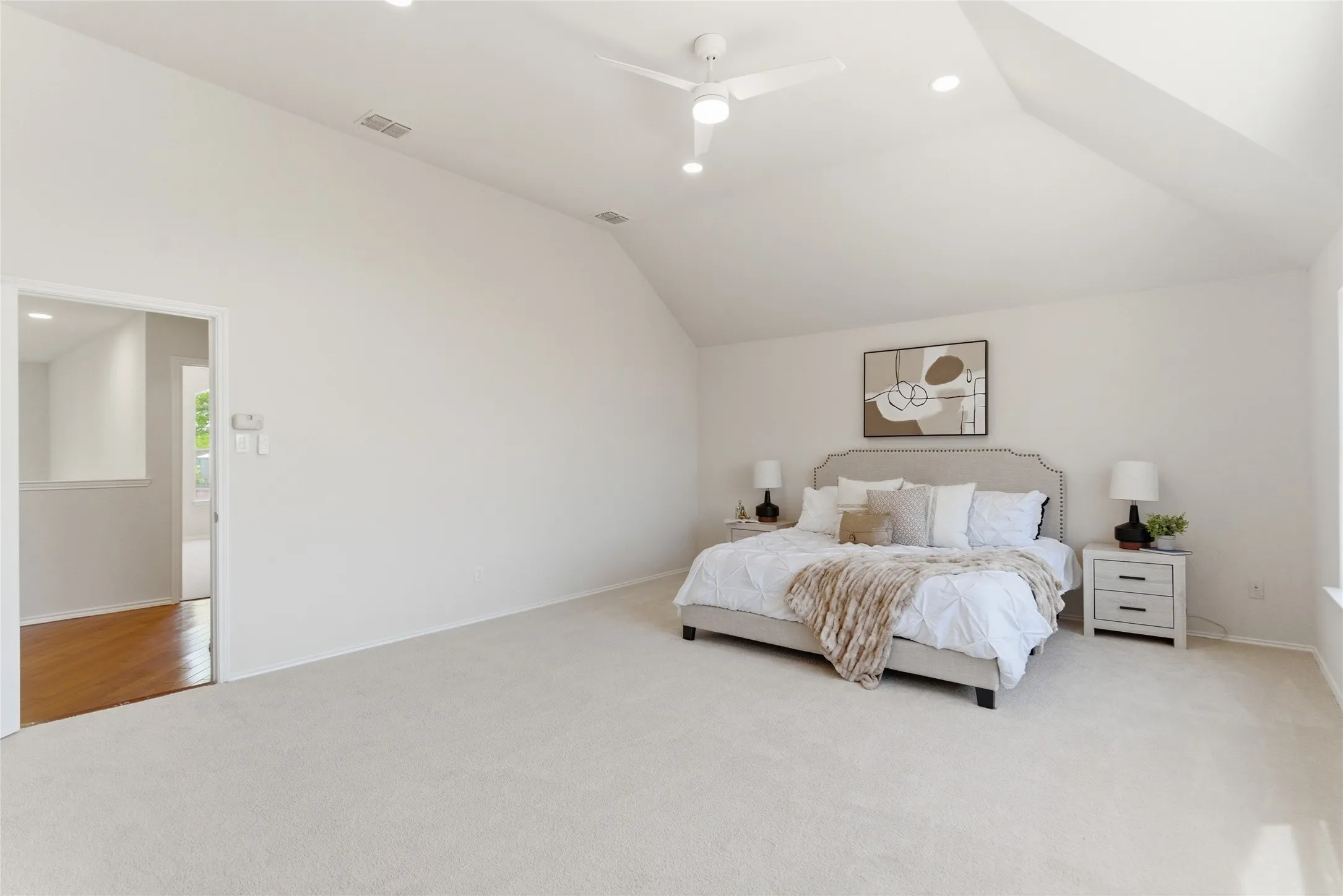 Vaulted ceiling with a ceiling fan, recessed lighting, and soft carpet flooring