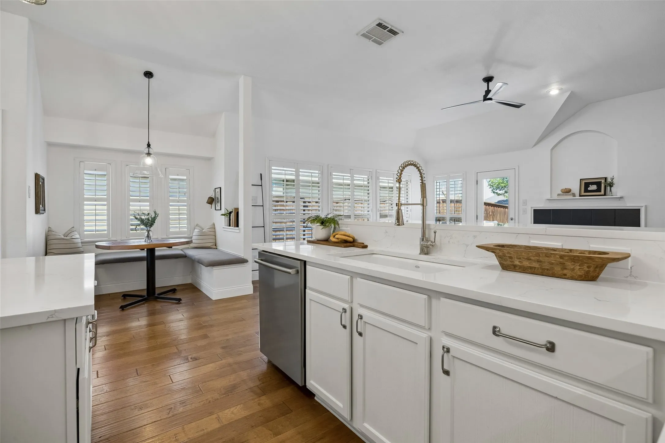 A farmhouse sink, Stainless steel dishwasher, drawer and cabinet hardware, plus open to the everyday dining nook!