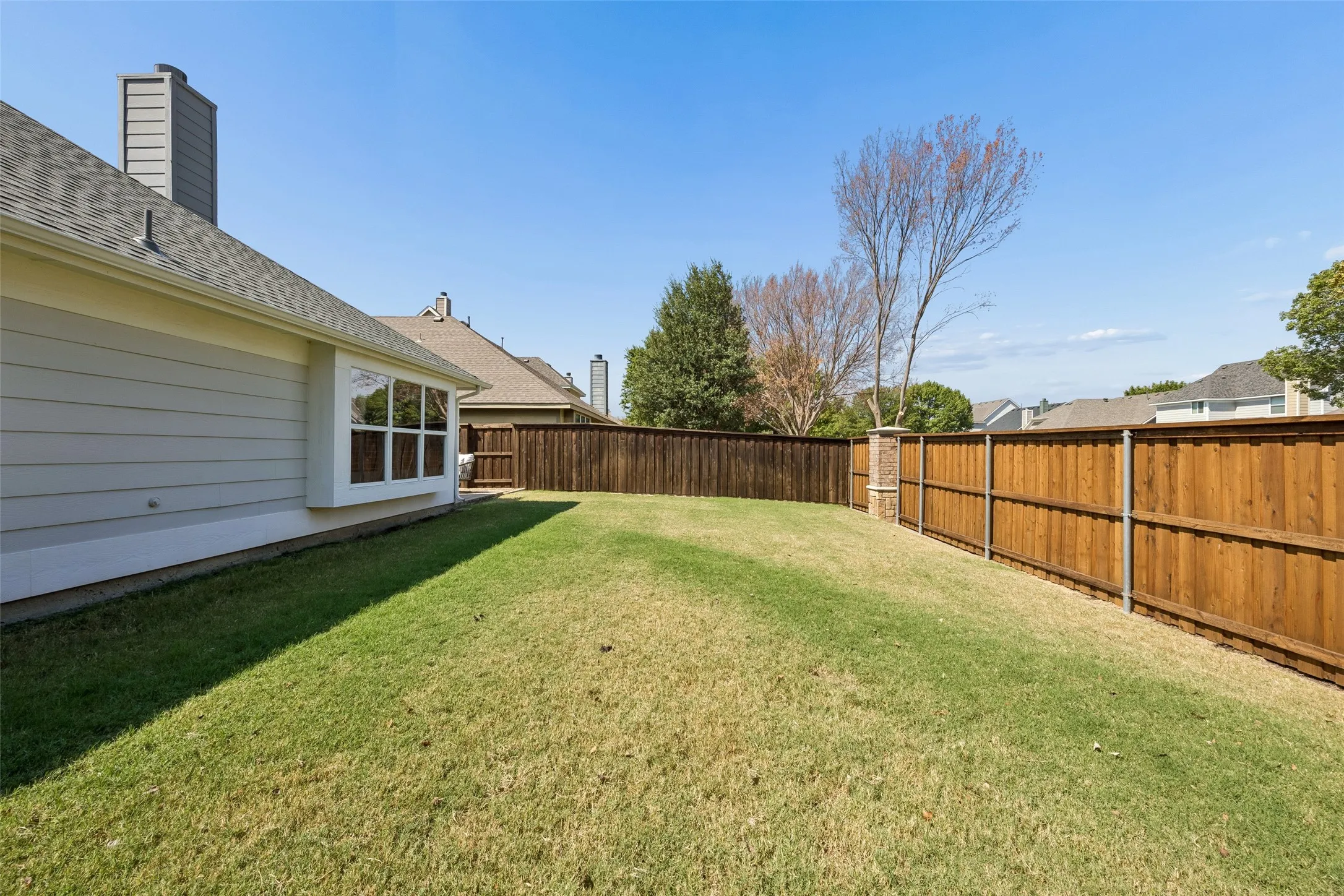 1. Generous outdoor space continues around the home, adding to the usable backyard area.
