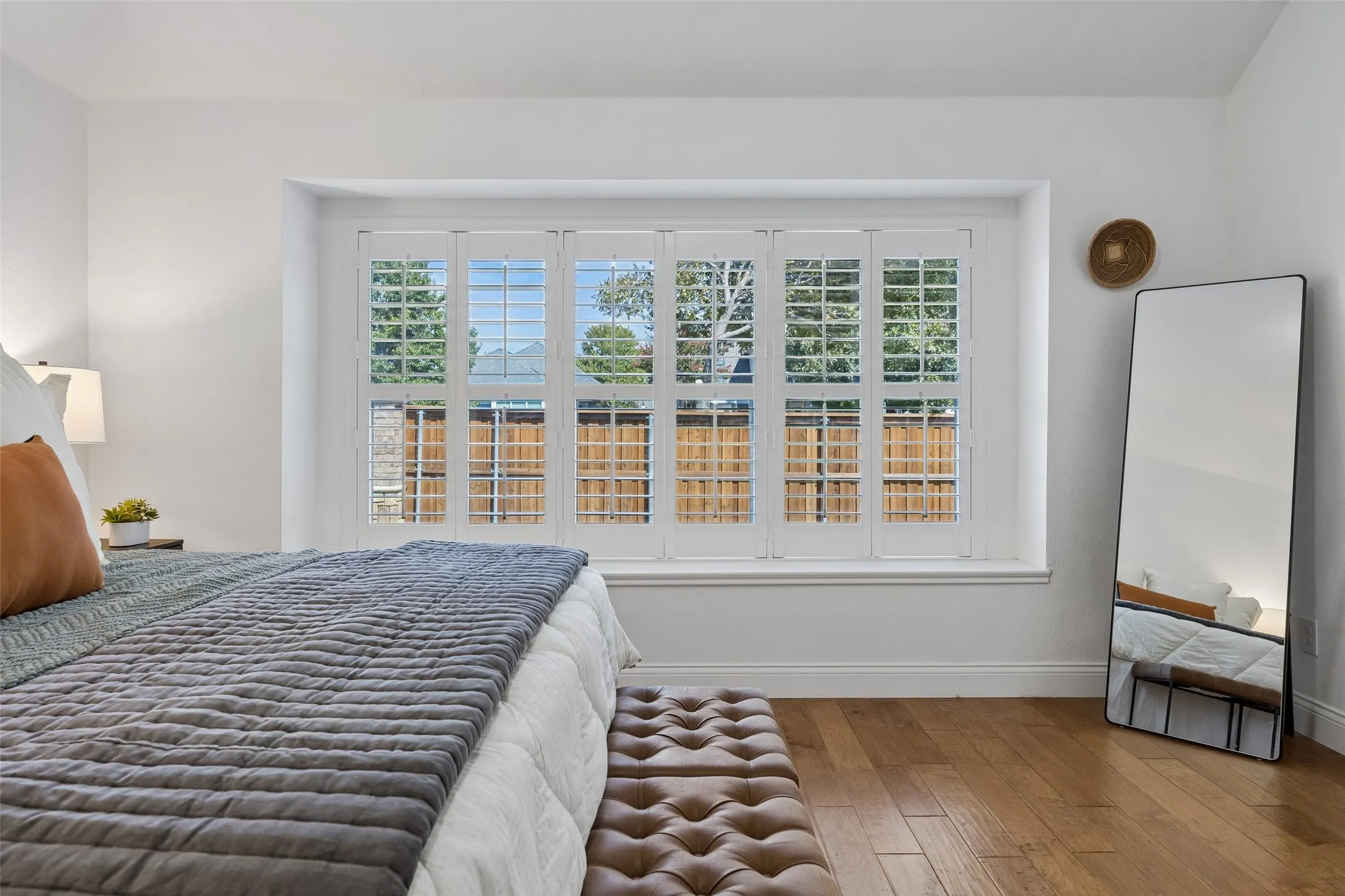 Large windows with plantation shutters create a bright and relaxing atmosphere.