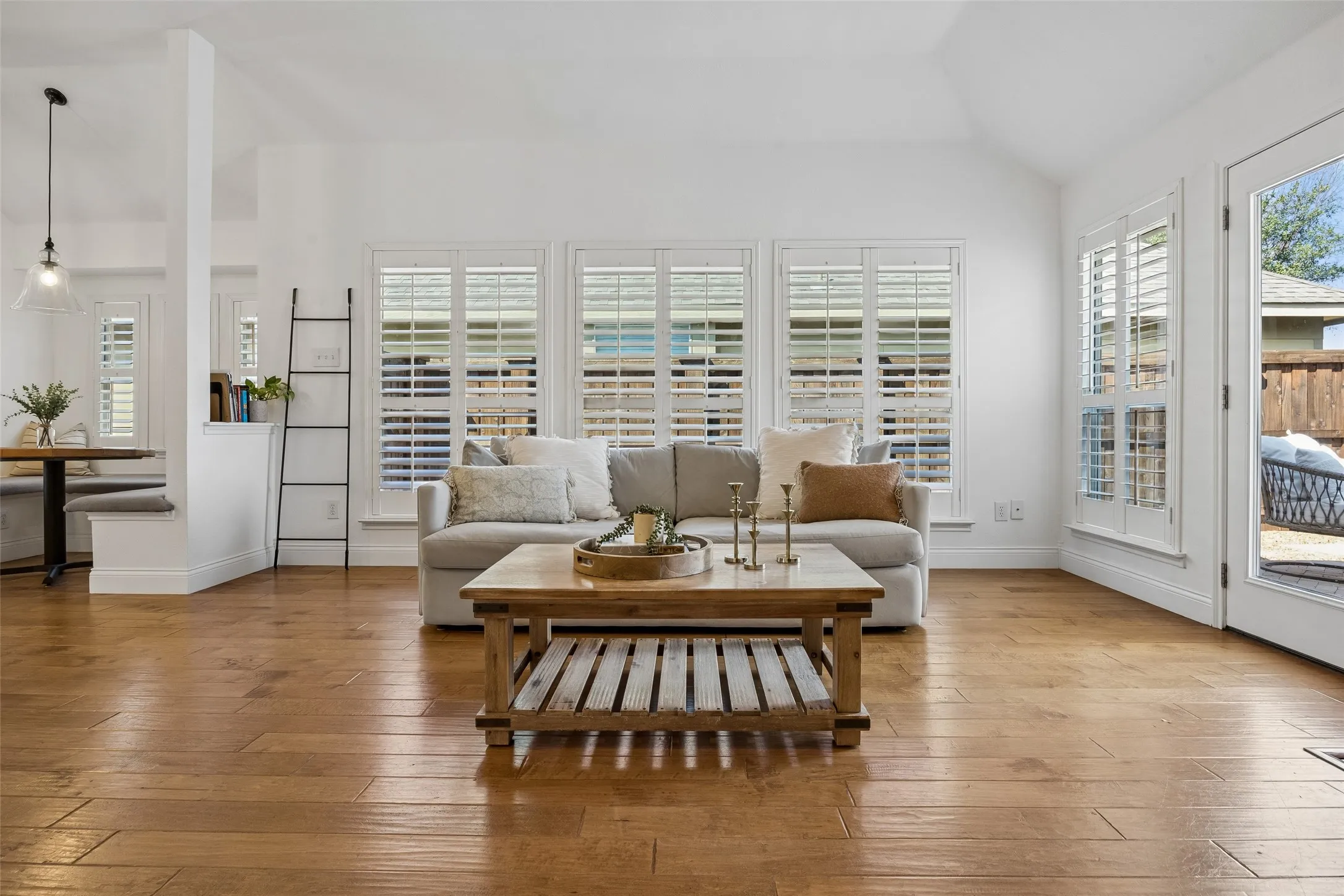 Plantation shutters bring in beautiful natural light while the fireplace creates a welcoming focal point.