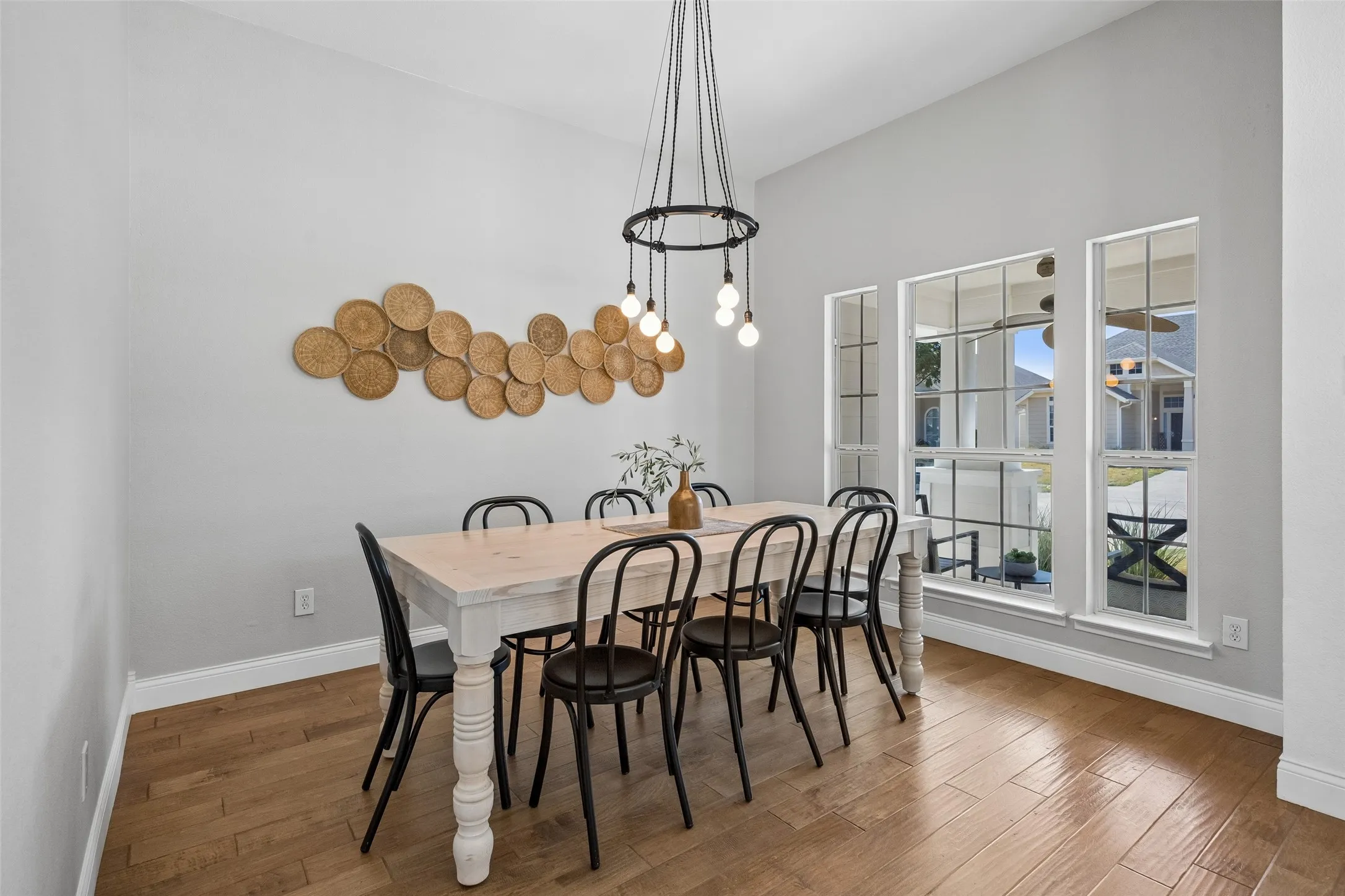 A warm and welcoming dining space with large windows and plenty of room to gather.