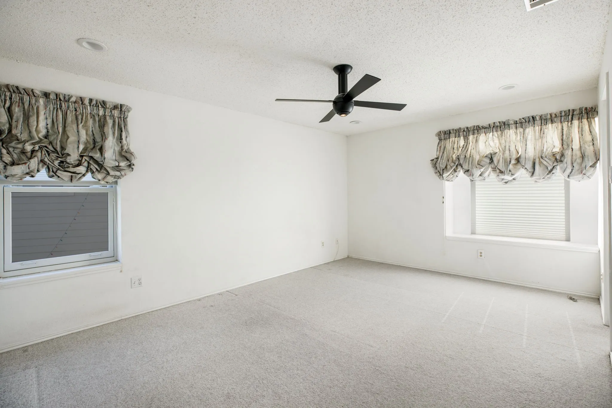 White walls with carpet flooring, recessed lighting, and a ceiling fan