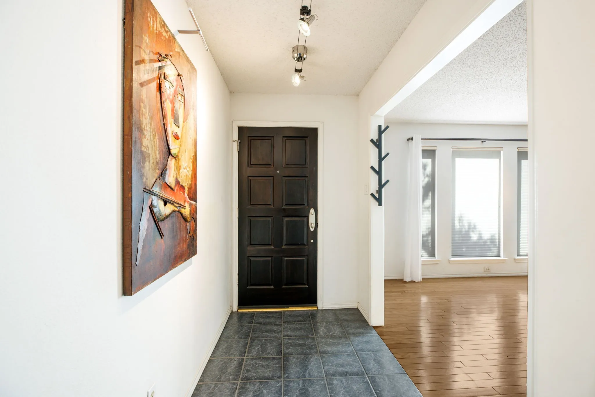 Entryway featuring dark tile flooring and a paneled entry door