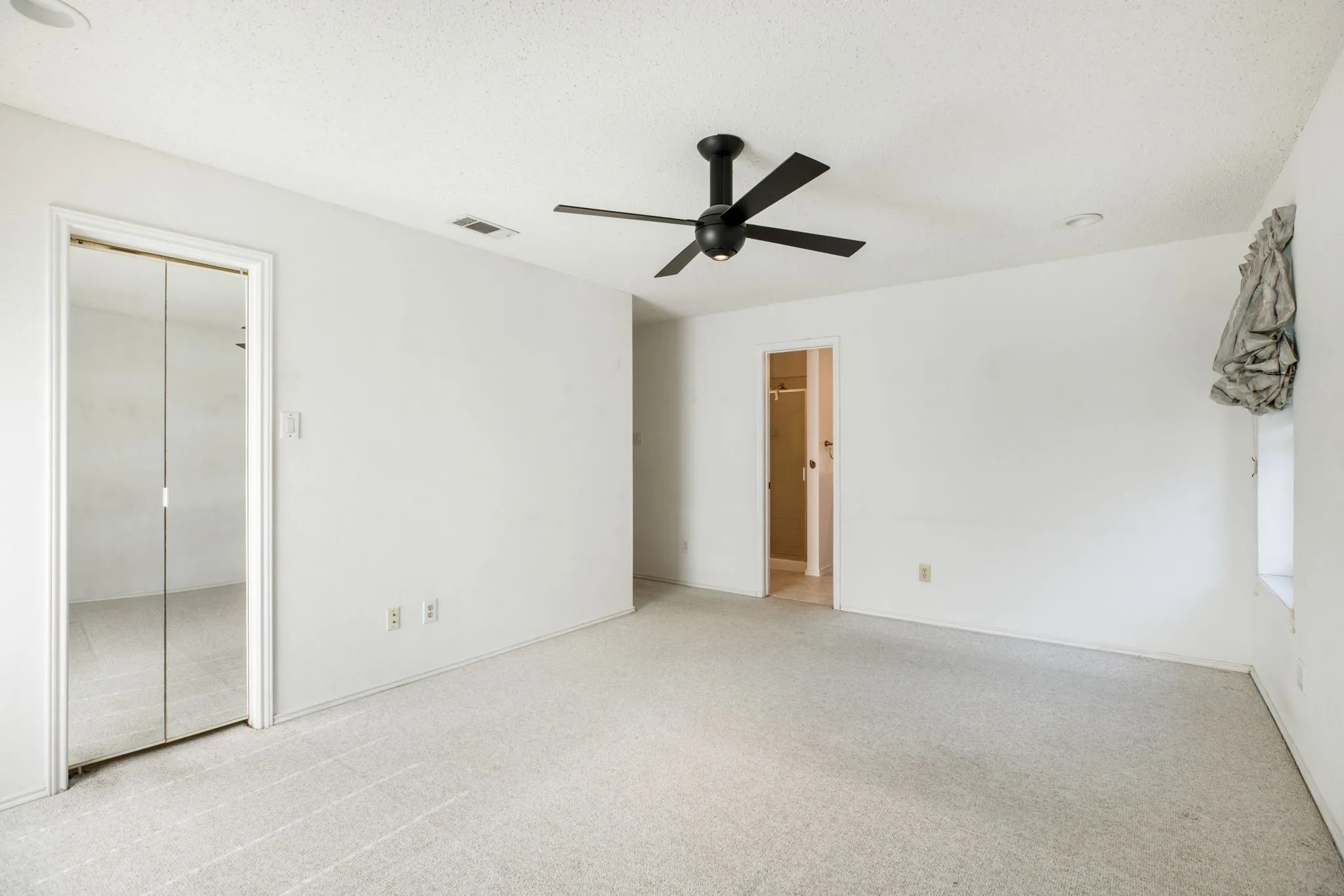 White walls with light-toned carpeting