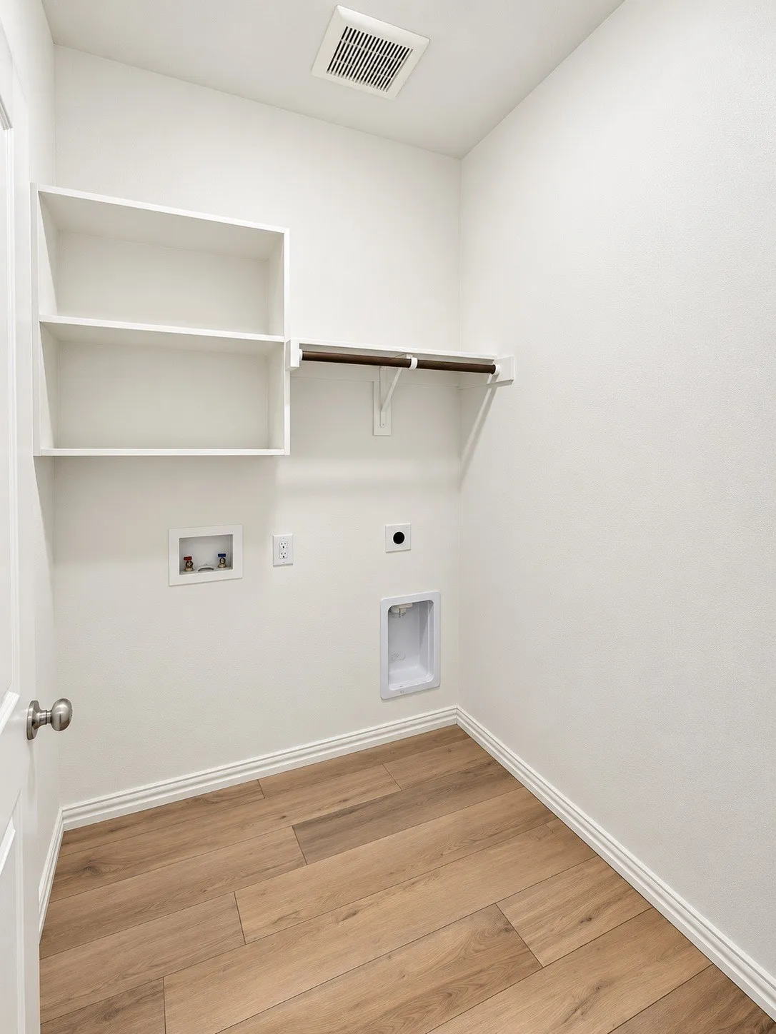 Built-in shelving, hanging rod, wood-finish flooring, and crisp white walls