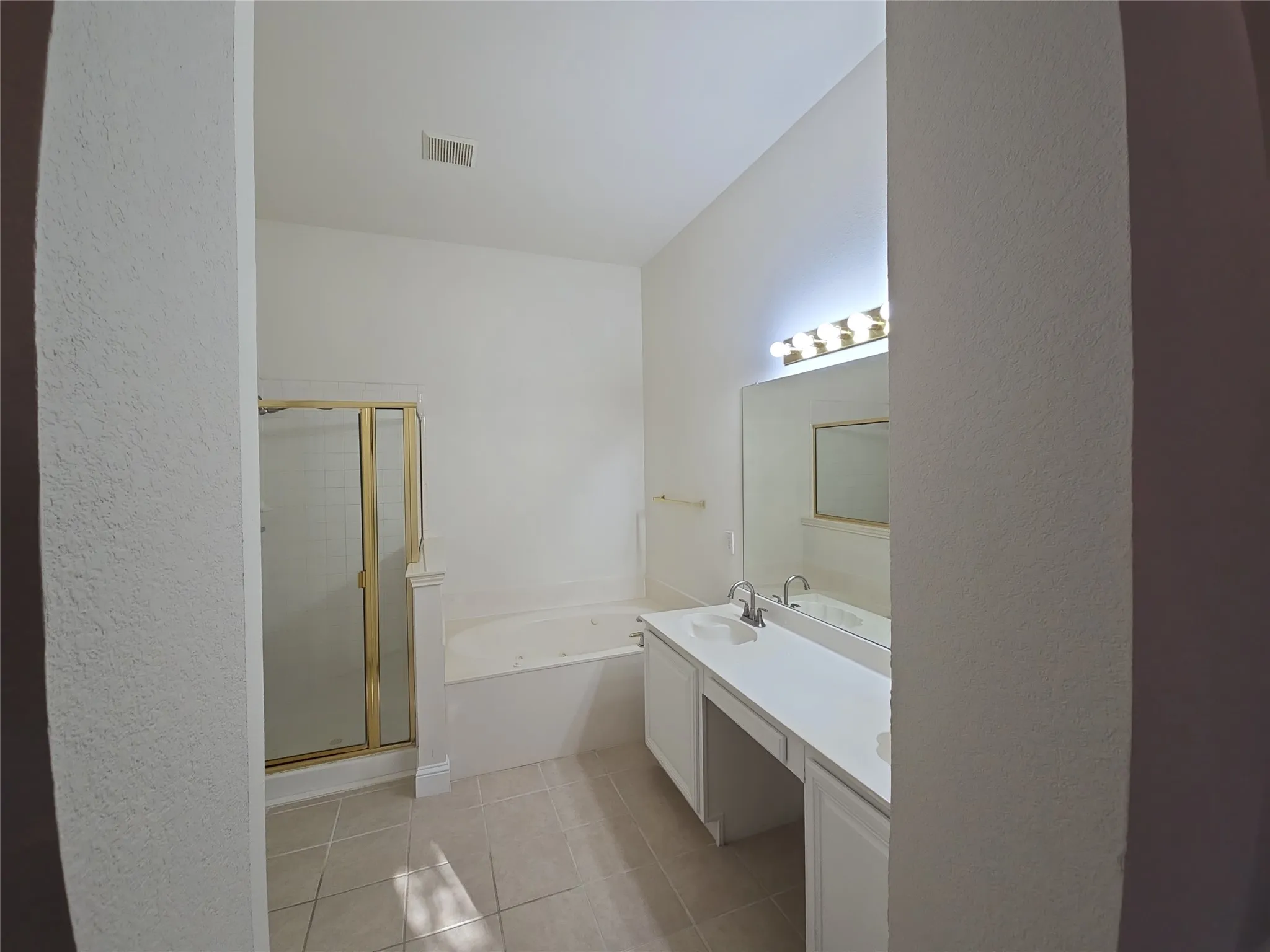 Dual vanity with integrated sinks, built-in soaking tub, and enclosed shower