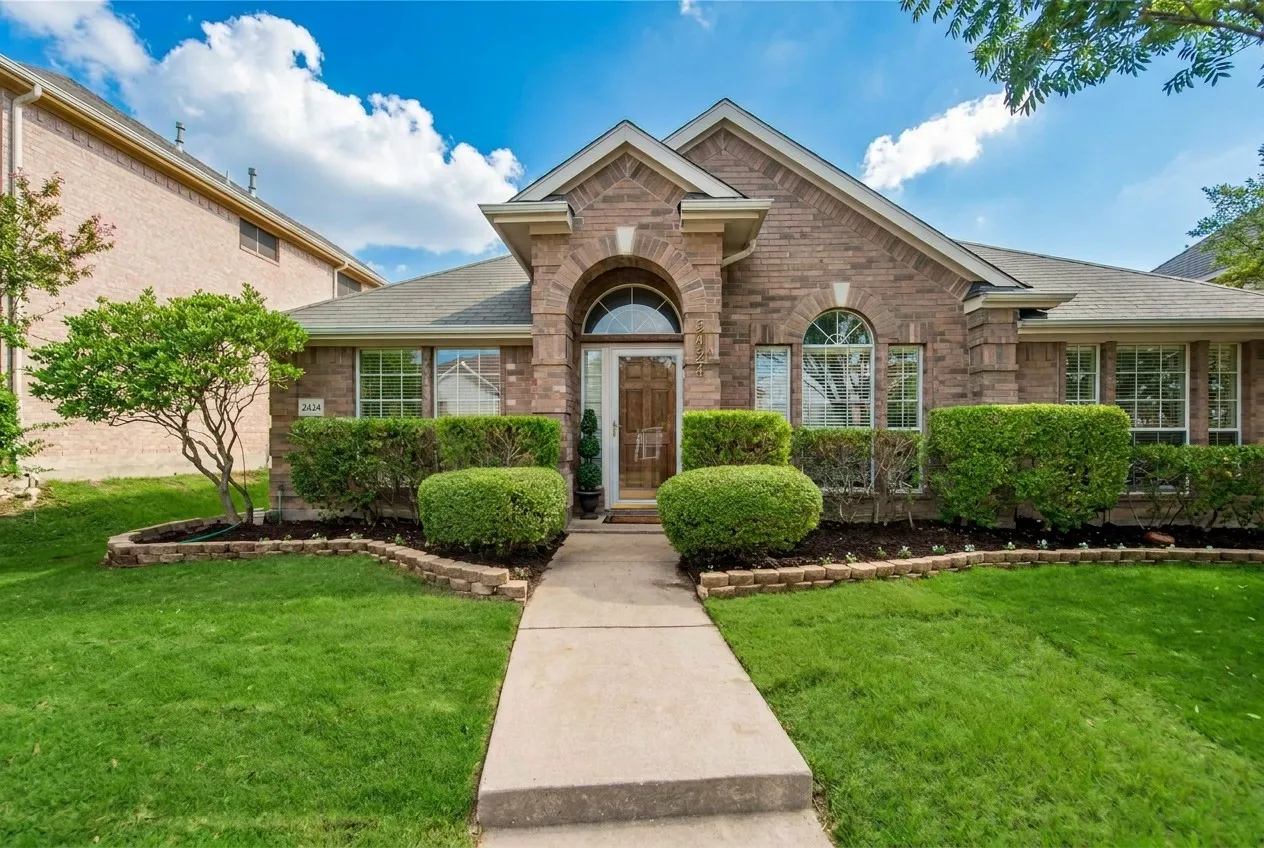 Brick exterior with arched entry and transom window