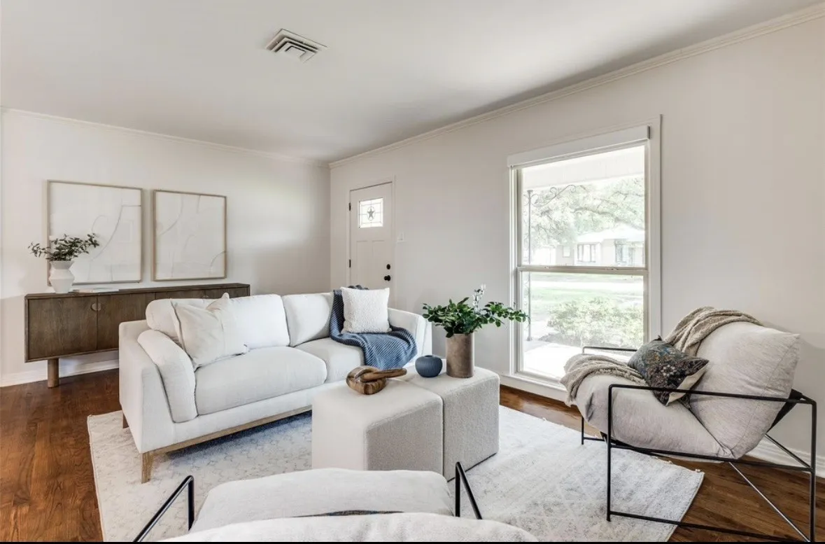 Hardwood flooring, white walls, and a white entry door with a decorative glass insert