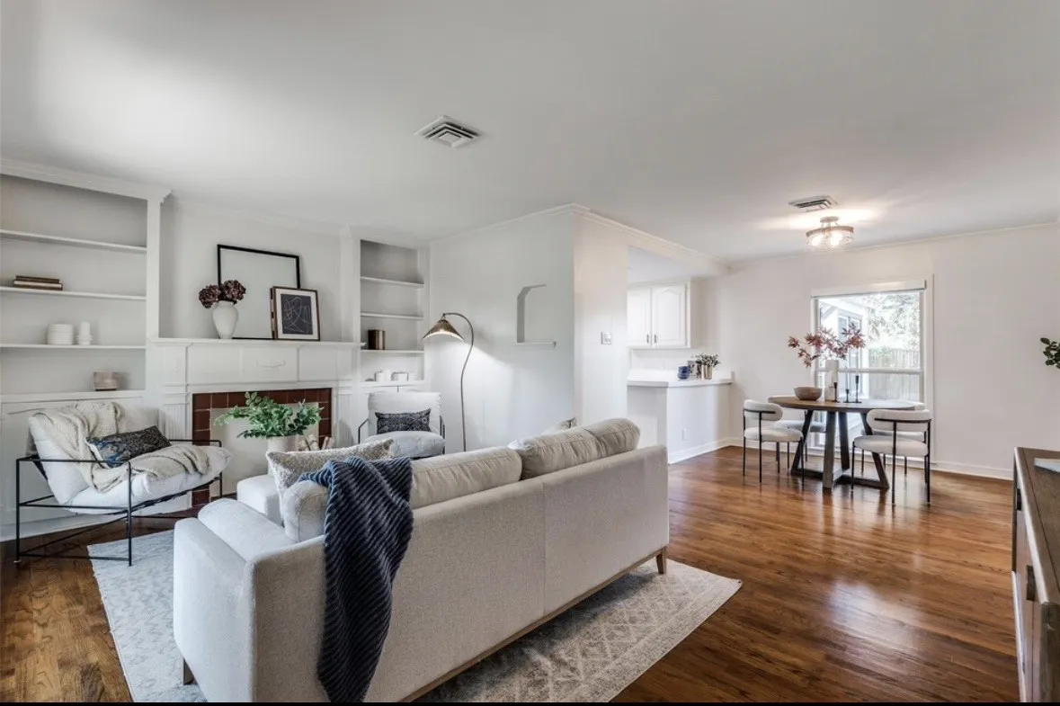 Warm wood-finish flooring extends through this open living space