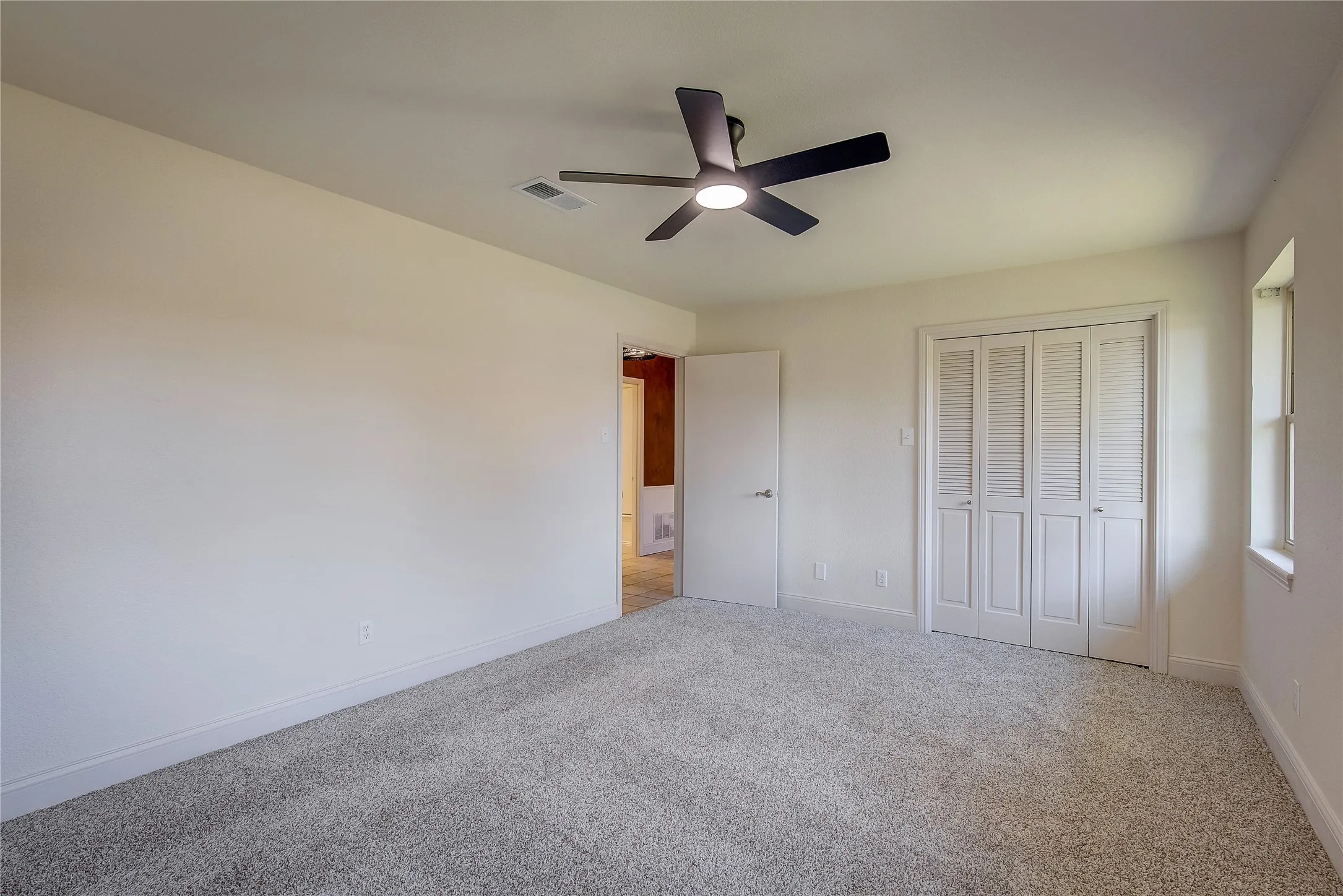 Bedroom 2 has fresh paint and carpet and a double-door closet. Bedrooms 2 & 3 are separate from the primary suite.