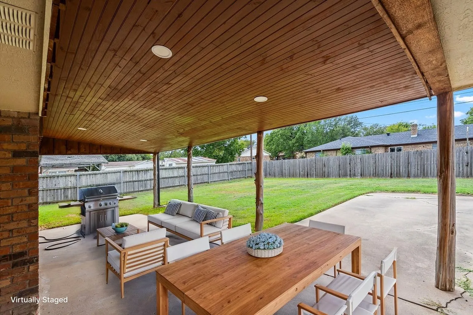 Covered back porch with concrete open patio space; tons of entertainment and hangout options, in a big fenced yard!