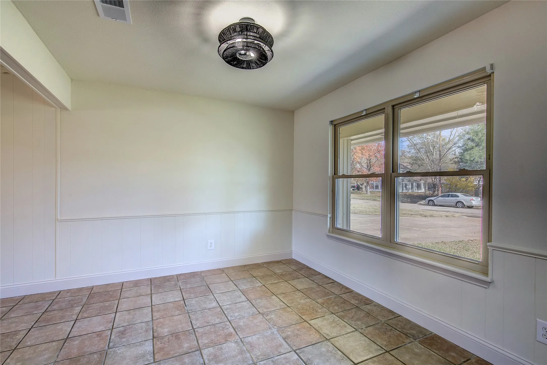Dining area has large windows and matching light fixture to living room