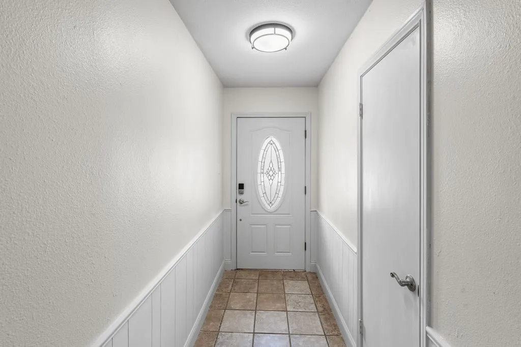 Bright and welcoming entry hall has coat closet.