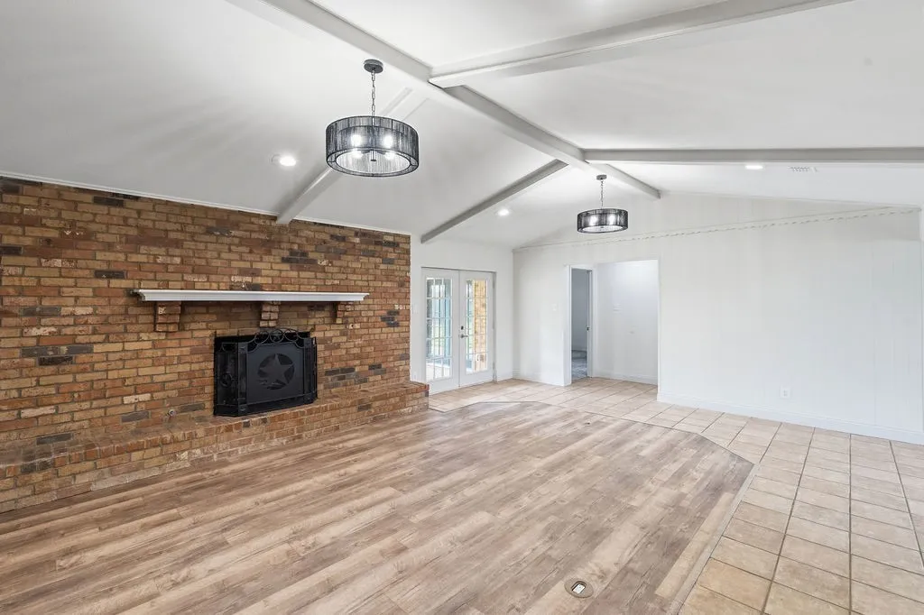 Huge living room with gas fireplace with long raised brick hearth and wall