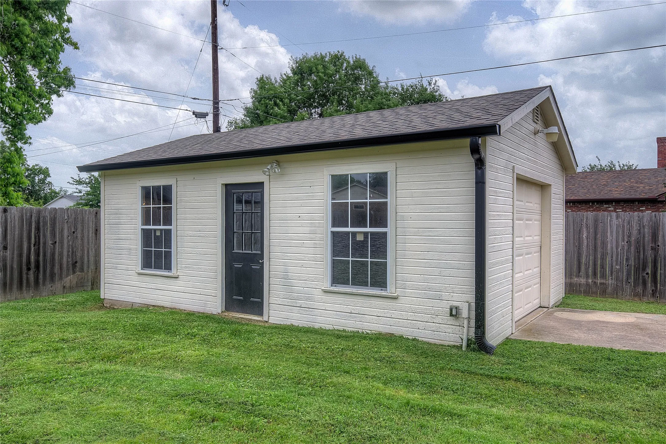 Front yard has dedicated concrete drive through back yard gates that lead to the workshop with electricity