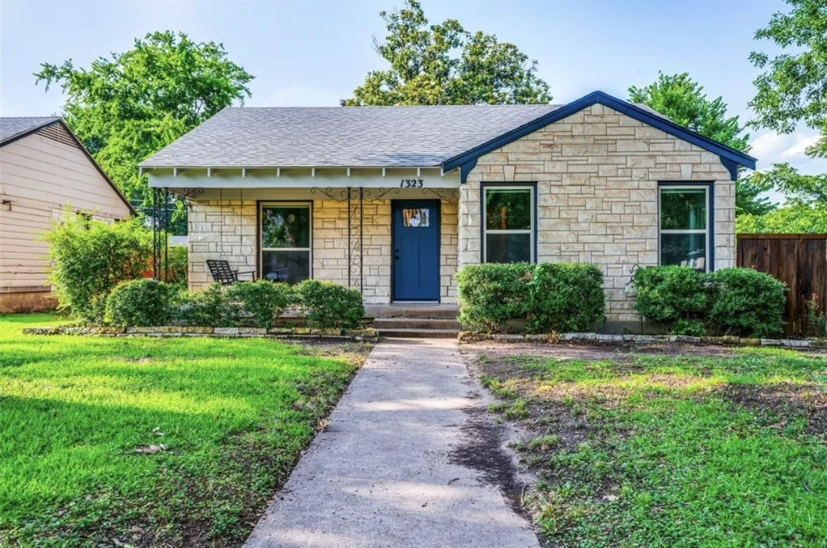 Stone veneer exterior with a contrasting blue front door and trim