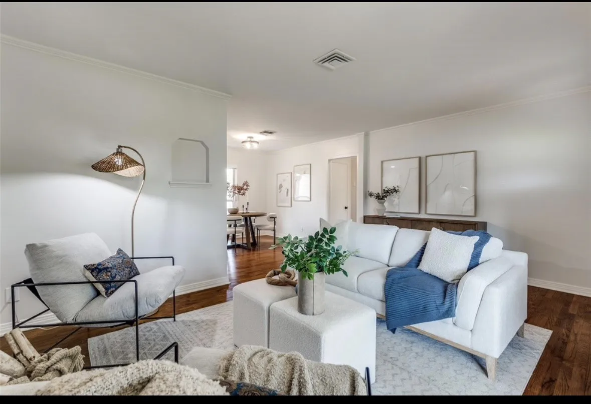 Hardwood flooring, crown molding, recessed lighting, and a defined architectural niche