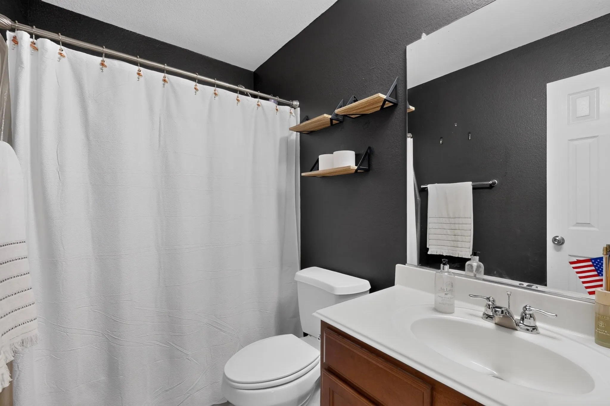 Vanity with white countertop, chrome faucet, and integrated sink