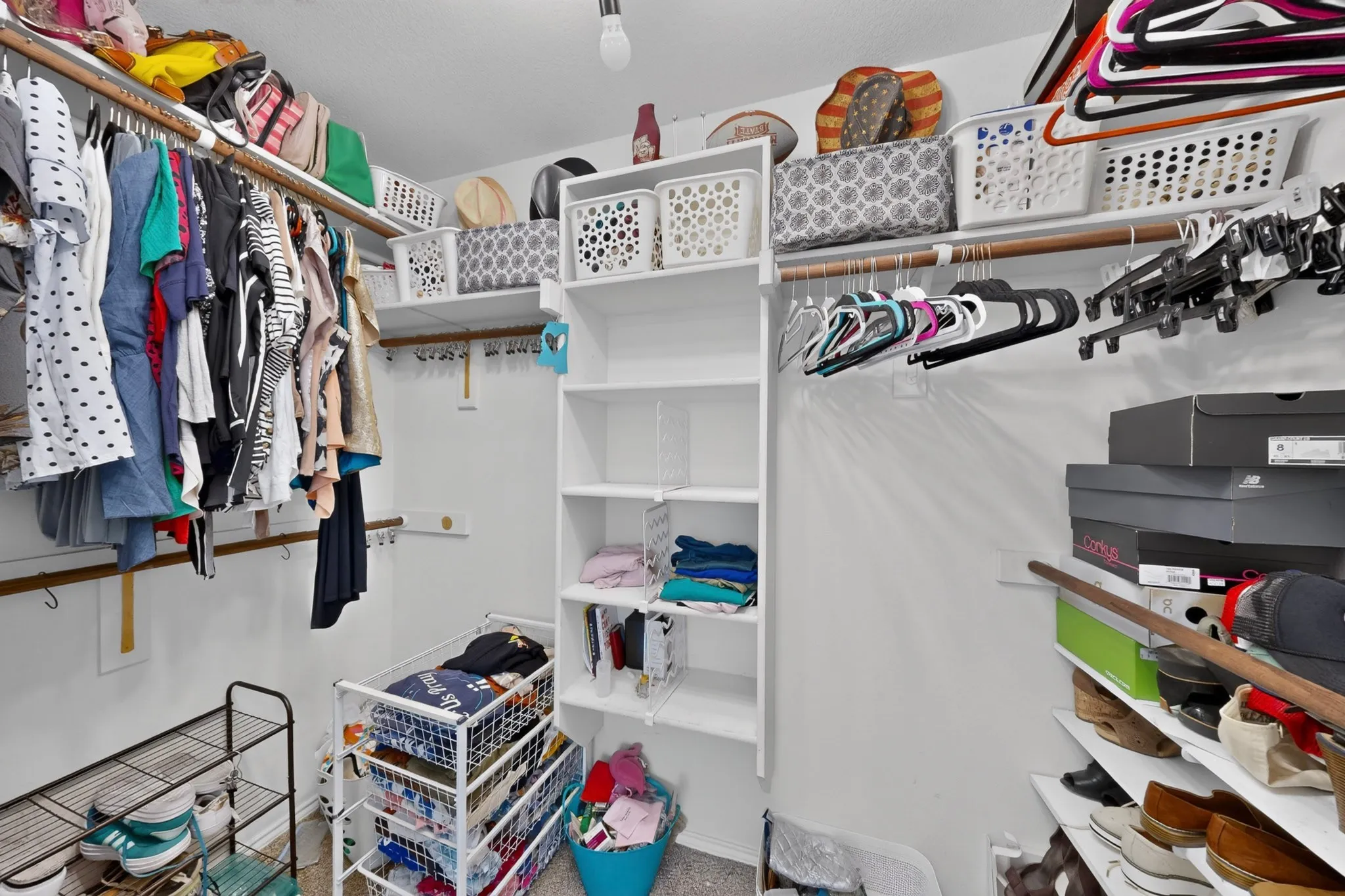 Integrated shelving system with multiple storage levels and clothing rods