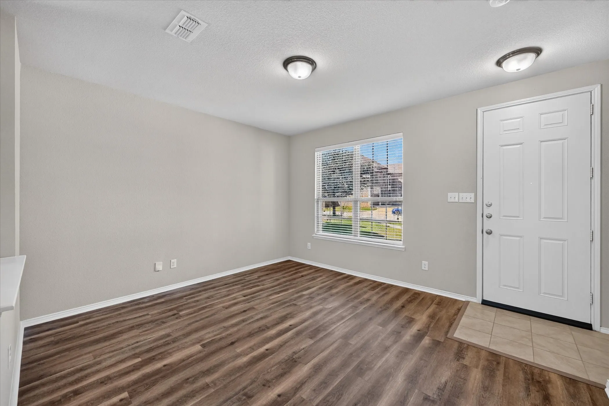 Wood-finish flooring throughout, complemented by light gray walls and white trim