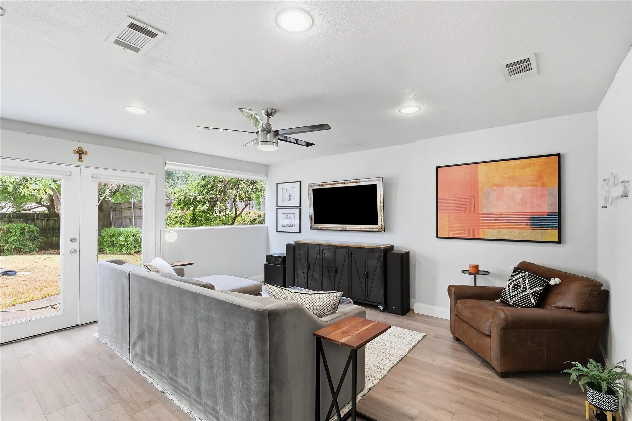 Wood-finish flooring throughout, recessed lighting, and a ceiling fan with integrated lighting