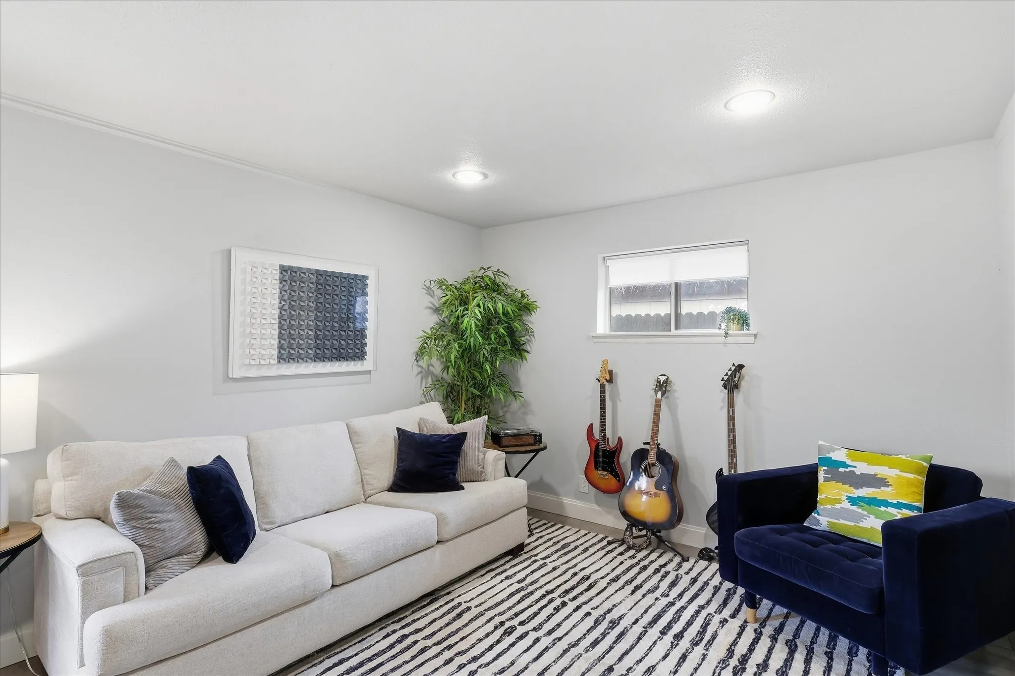 Recessed ceiling lighting, light gray wall finishes, a single-pane window, and faux wood-finish flooring
