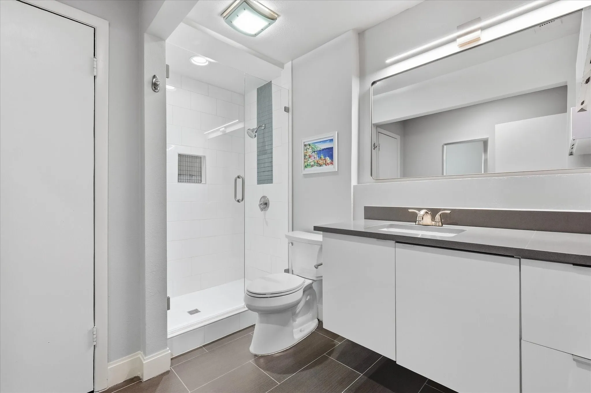 Primary Walk-in shower with clear glass enclosure and tiled walls