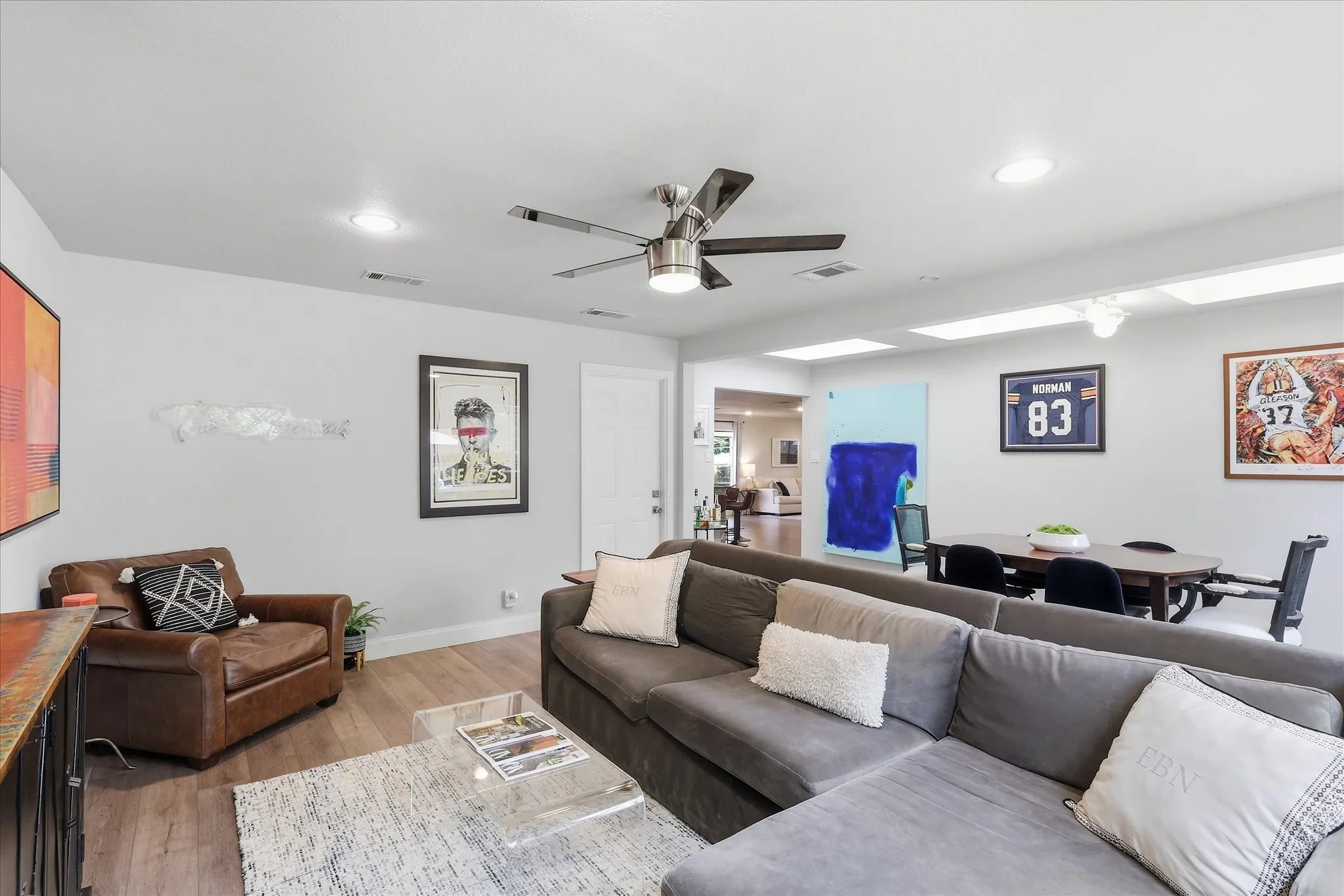 Recessed lighting, wood-finish flooring, and a ceiling fan with integrated lighting