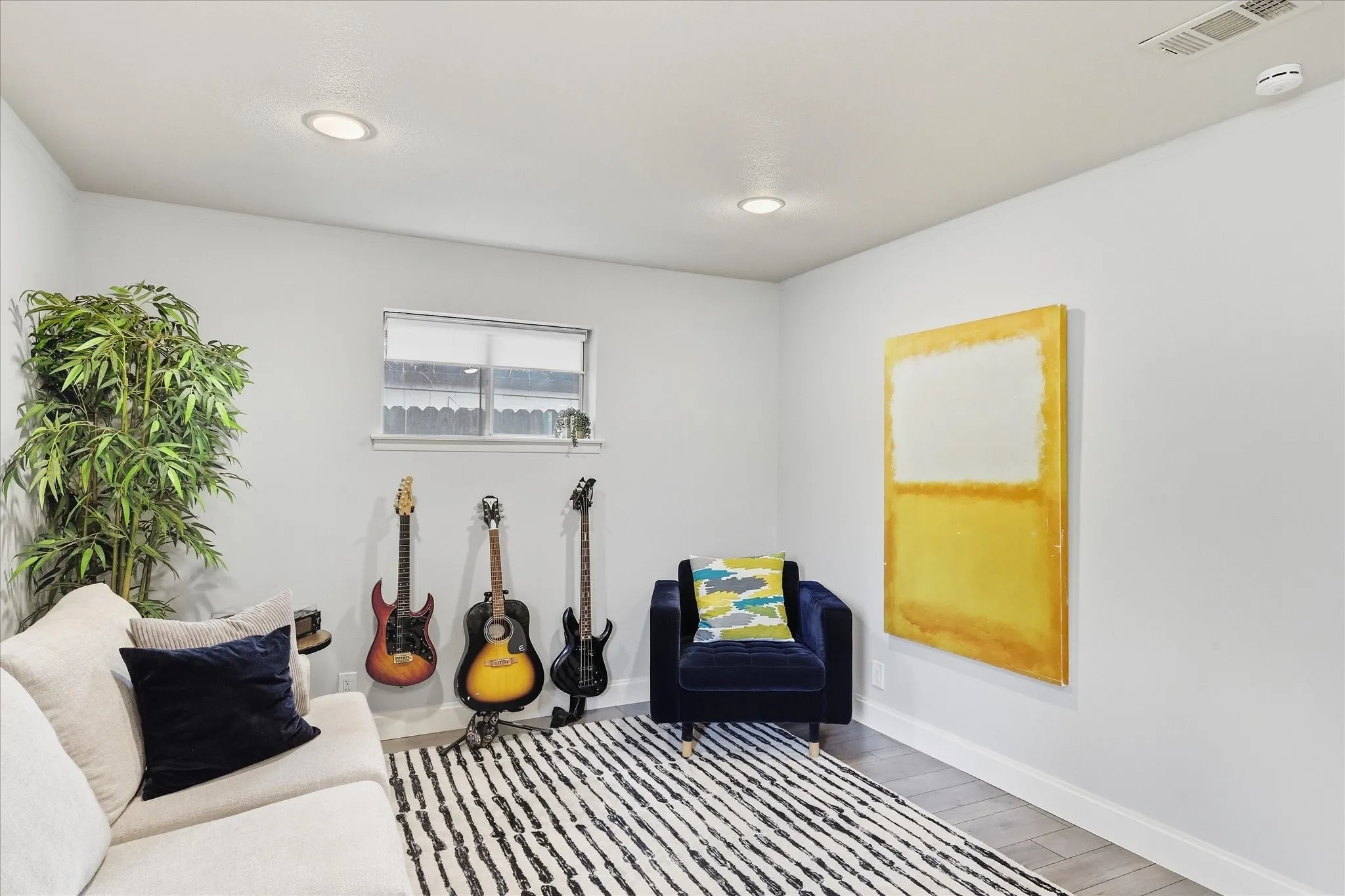 Recessed lighting illuminates neutral walls and faux wood-finish flooring