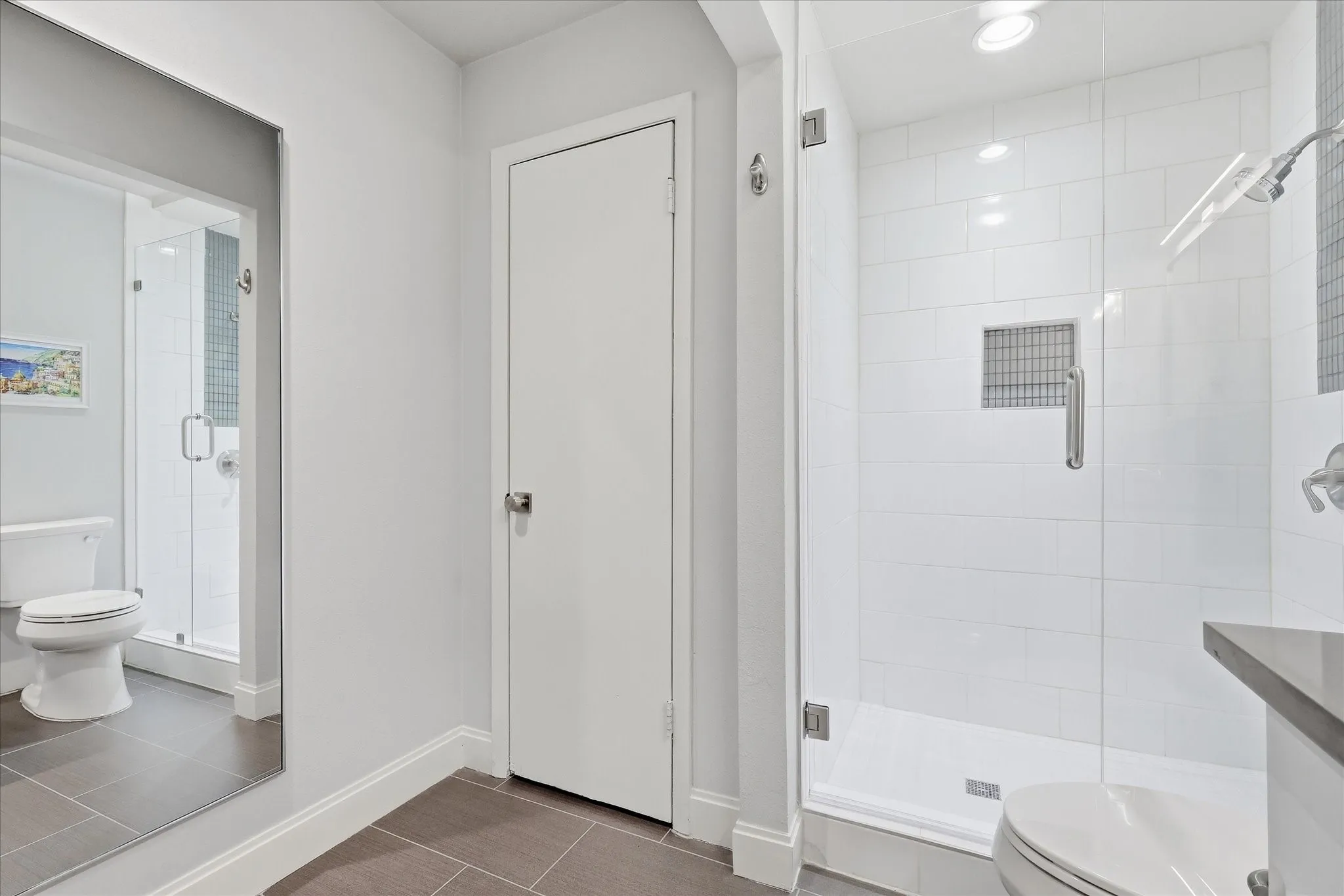 Primary Walk-in shower with clear glass enclosure and subway tile surround
