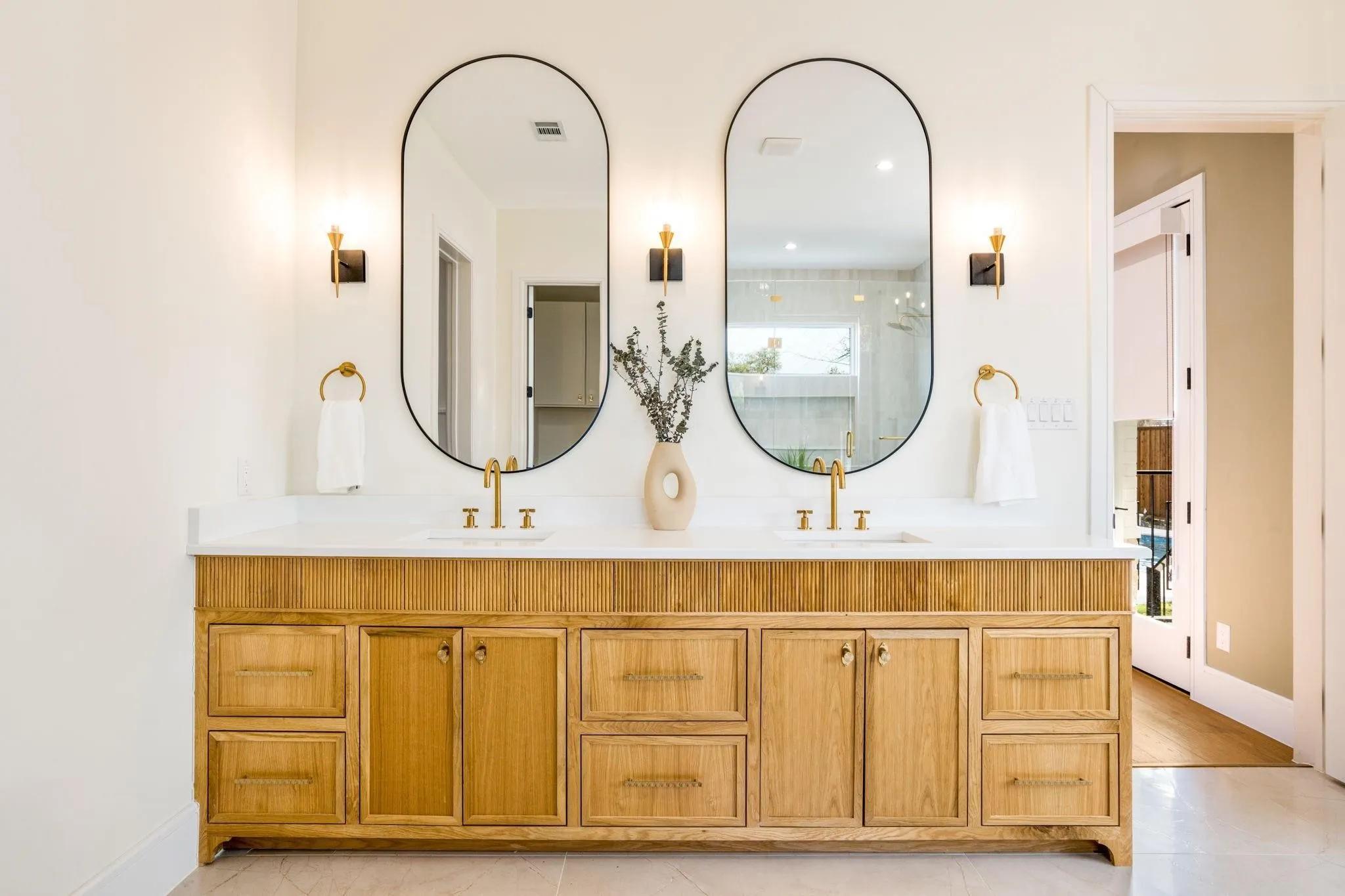 Dual vanity with a wood-finish cabinet and white countertop