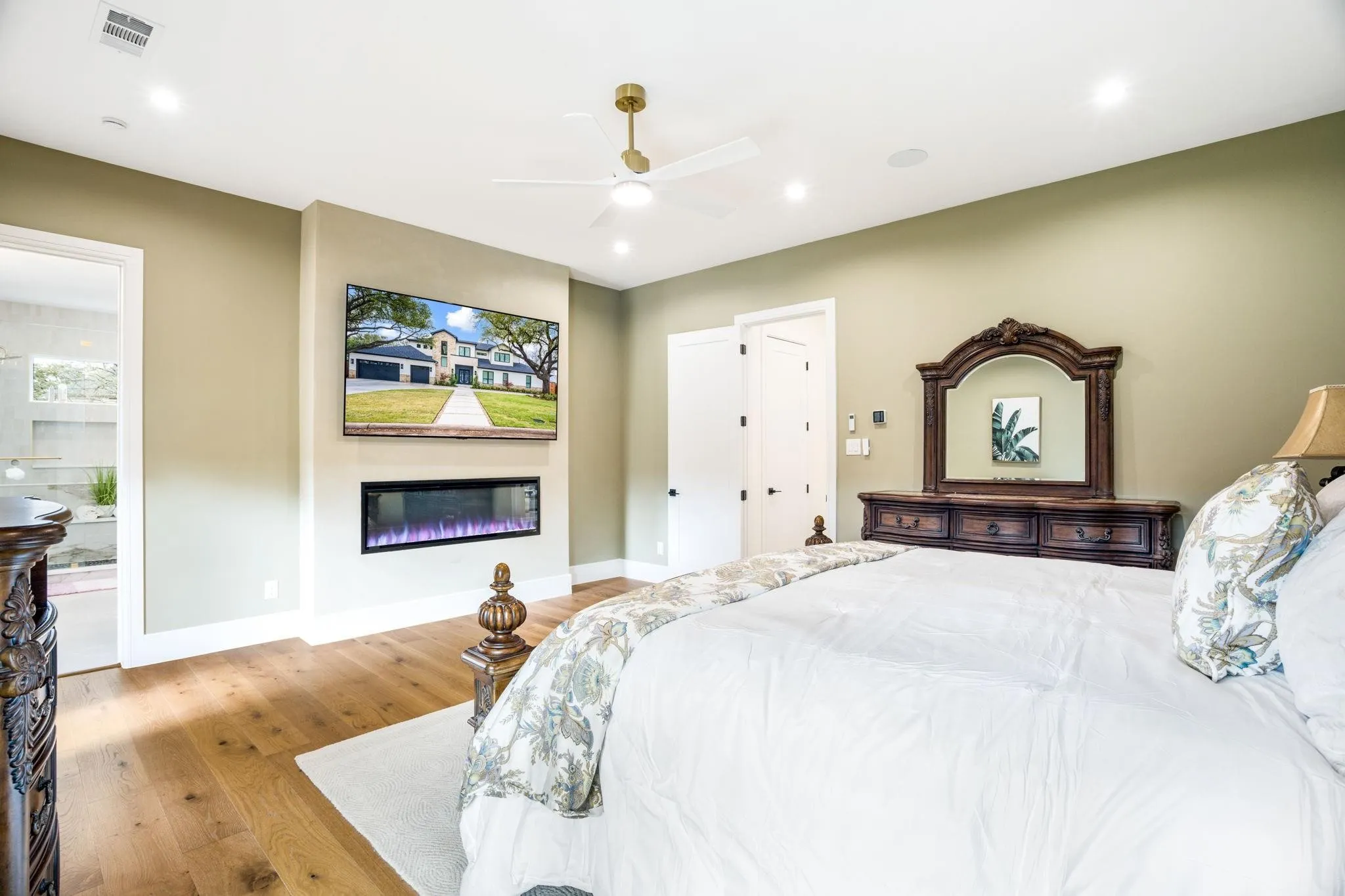 Wood-finish flooring, recessed lighting, and a ceiling fan