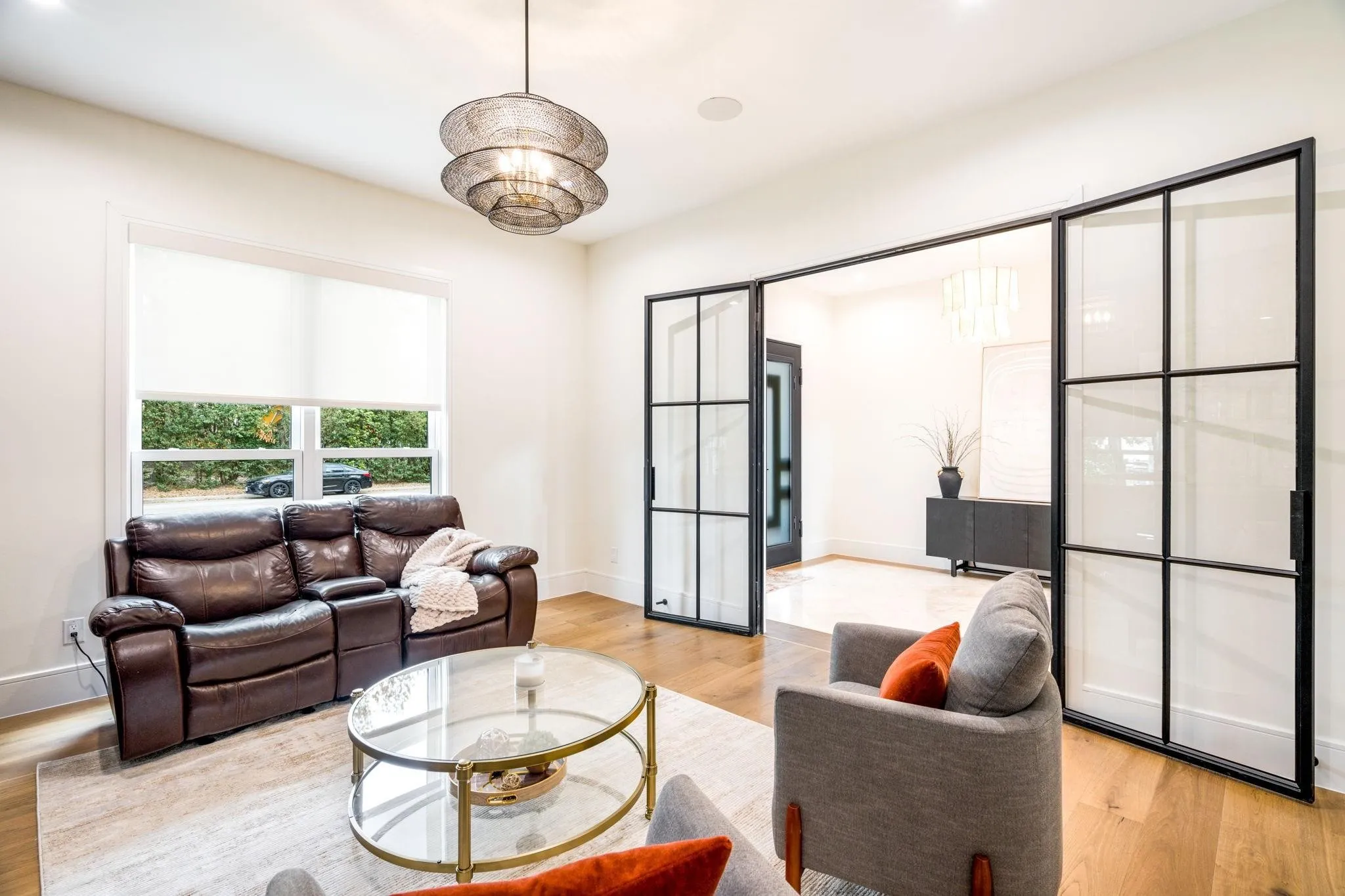Hardwood flooring, recessed lighting, and a contemporary chandelier