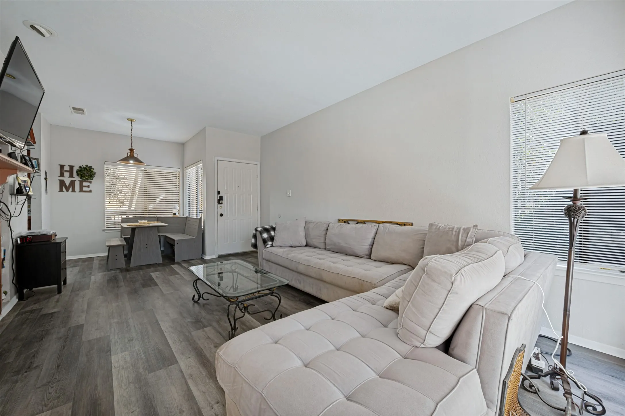 Wood-finish flooring throughout, with a built-in dining nook featuring bench seating