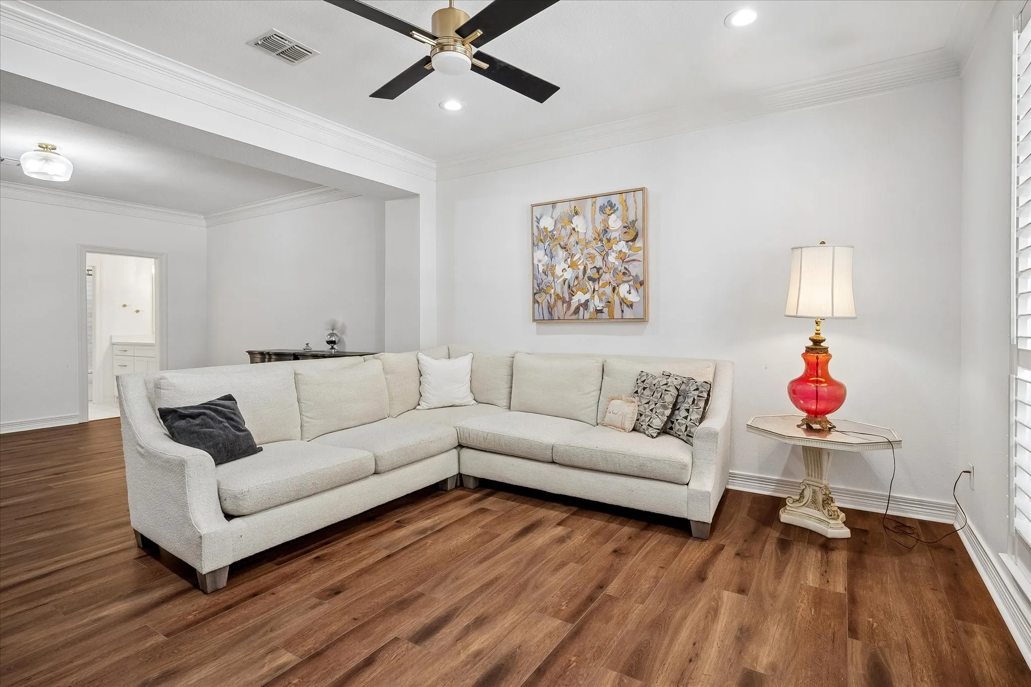 Wood-finish flooring, recessed lighting, and a ceiling fan with integrated lighting