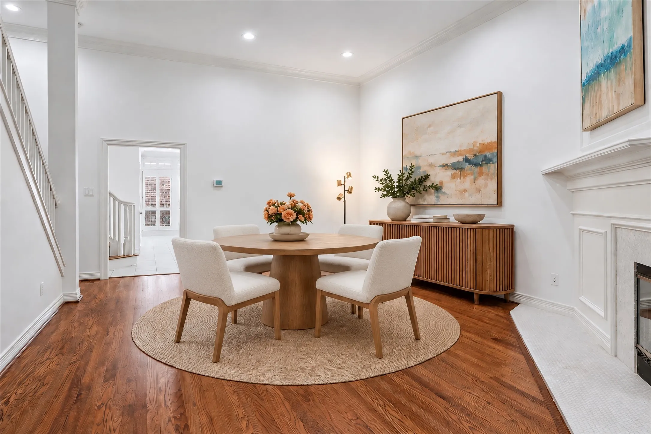Elegant dining room anchored by a round pedestal table and complemented by a circular area rug