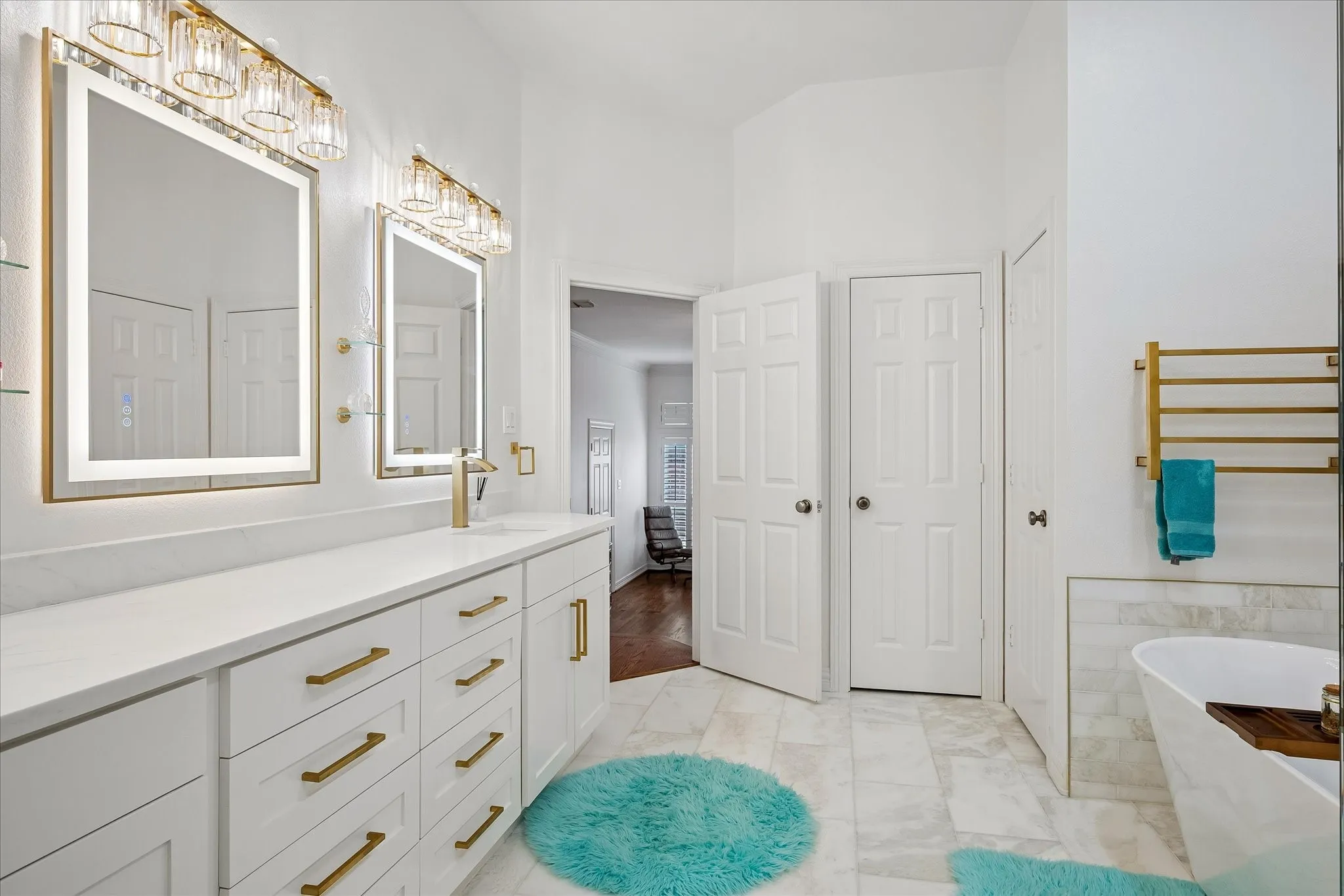 Dual vanity with white cabinetry and gold-finish hardware