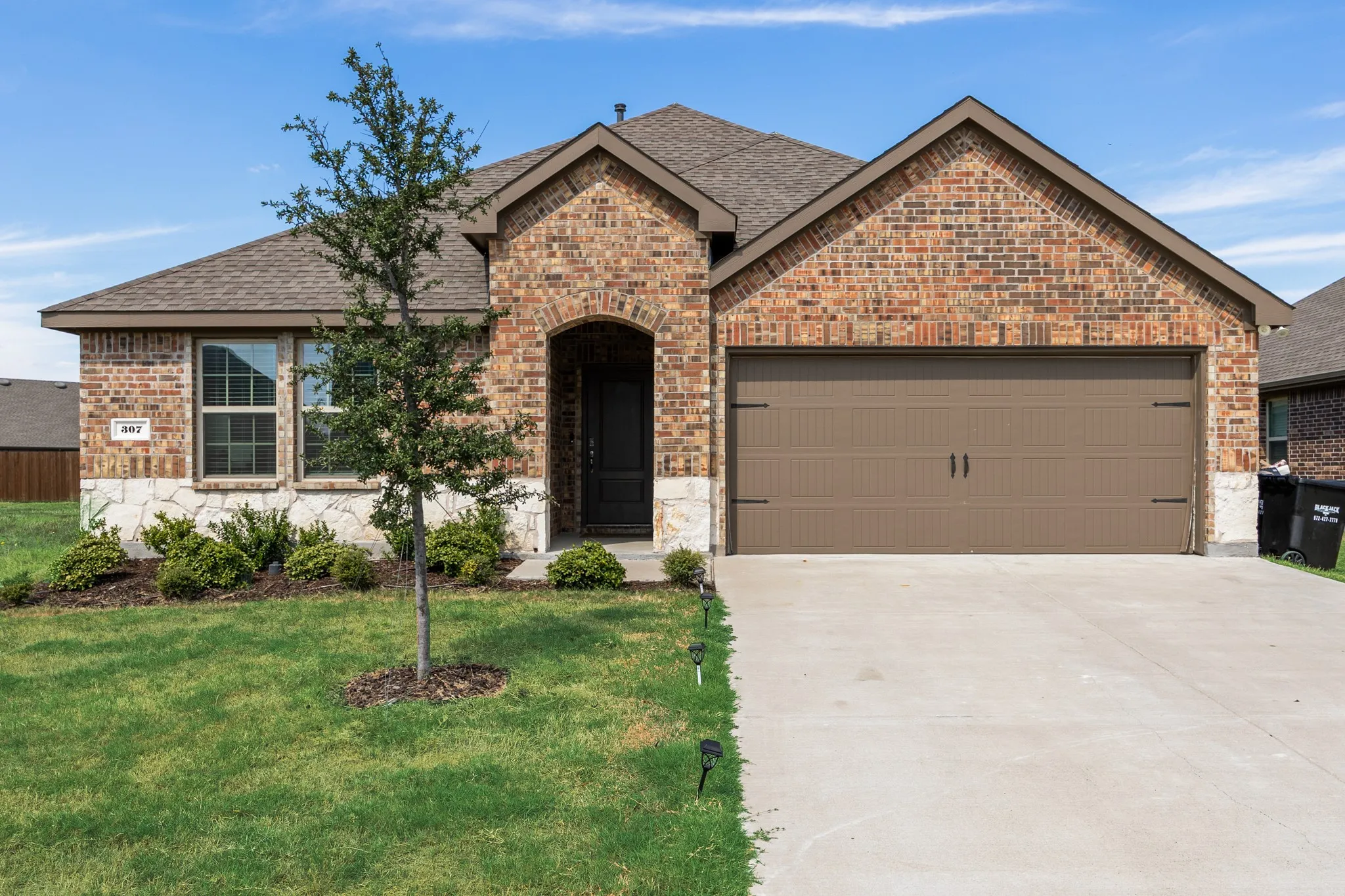 Brick and stone veneer exterior with an arched entryway