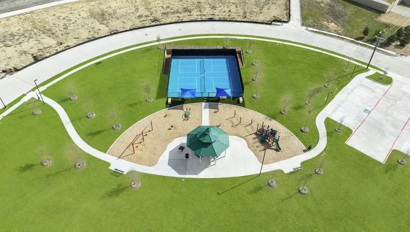 Manicured lawn with a dedicated tennis court, a covered gazebo, and a children's play area