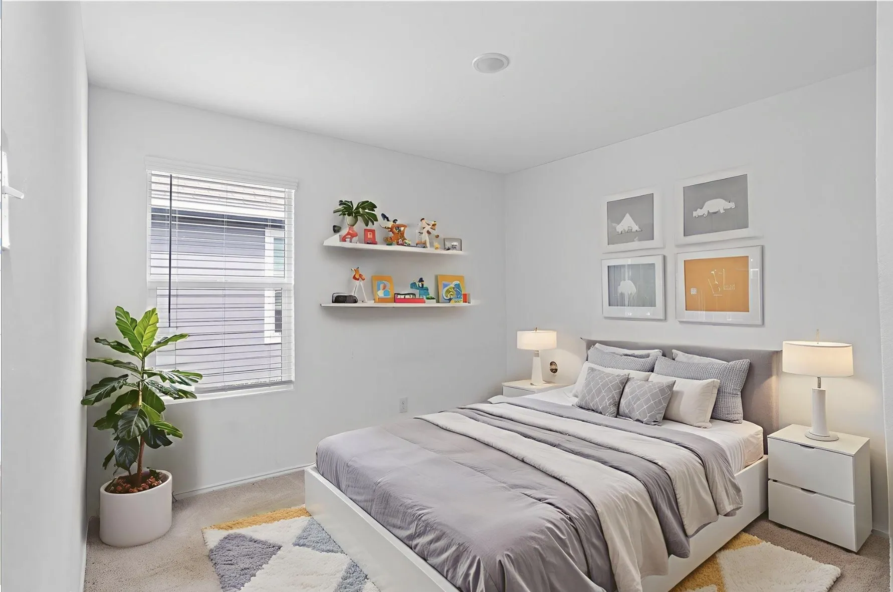 Recessed lighting, window with blinds, two wall-mounted shelves, light-toned wall paint, and carpeted flooring