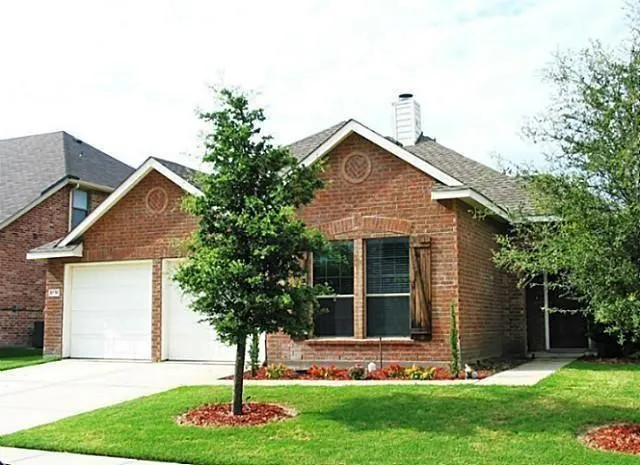 Brick exterior with a gabled roof and two-car garage