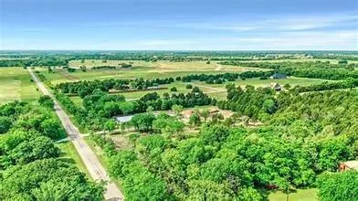 Expansive acreage featuring abundant mature trees and open clearings