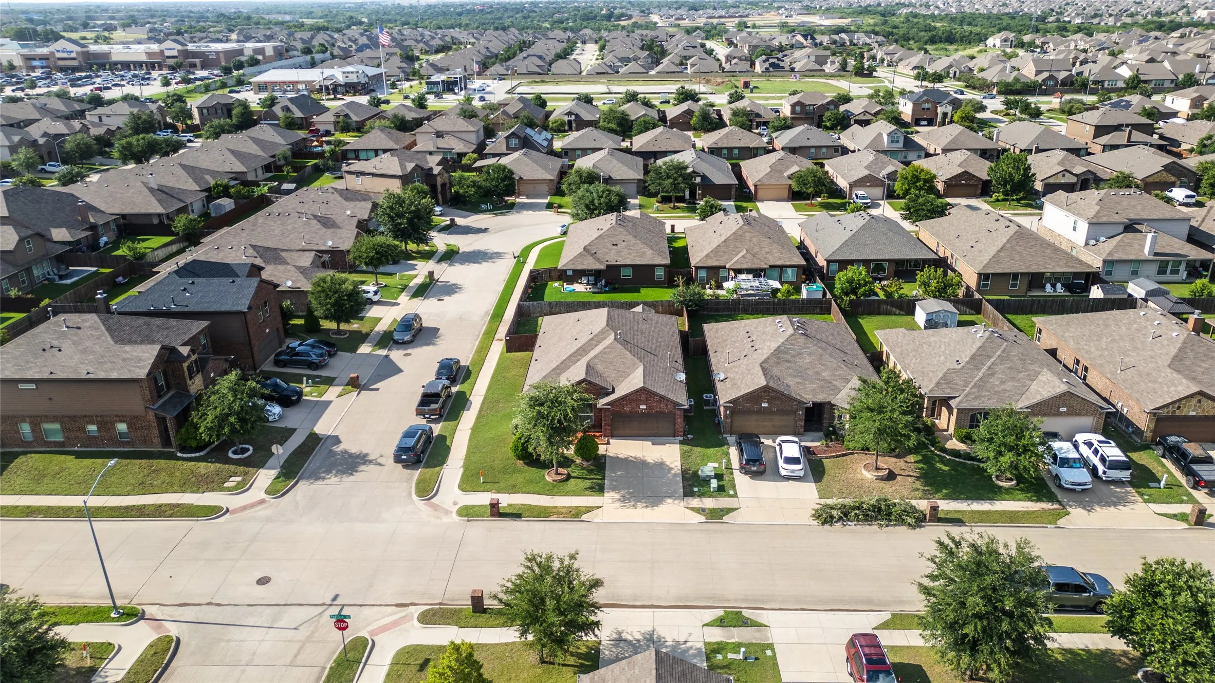 Residential neighborhood featuring a grid-pattern street layout, uniformly sized lots, and paved roadways