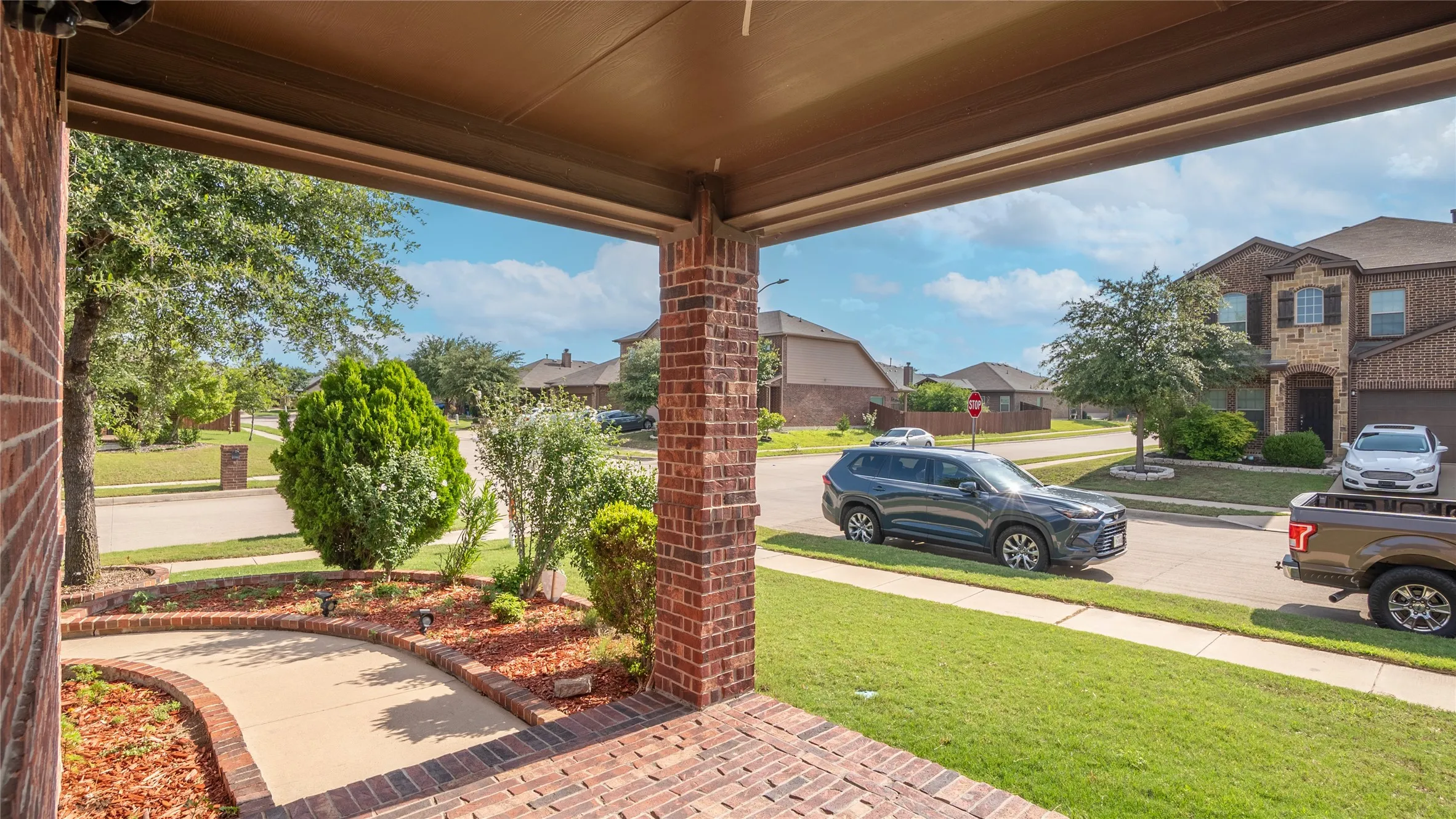 Covered porch with brick columns and a brick-patterned floor