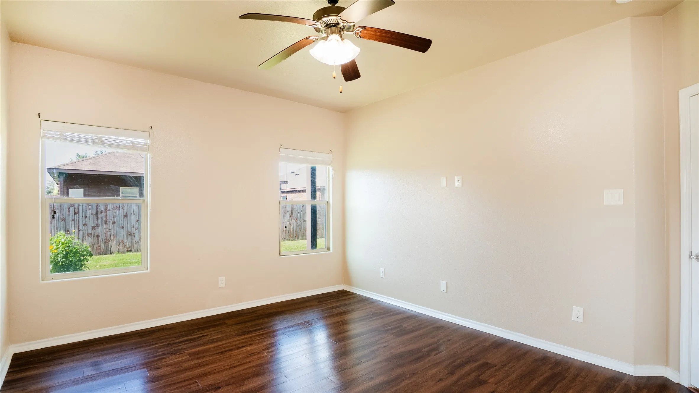 Wood-finish flooring with neutral wall paint and white trim