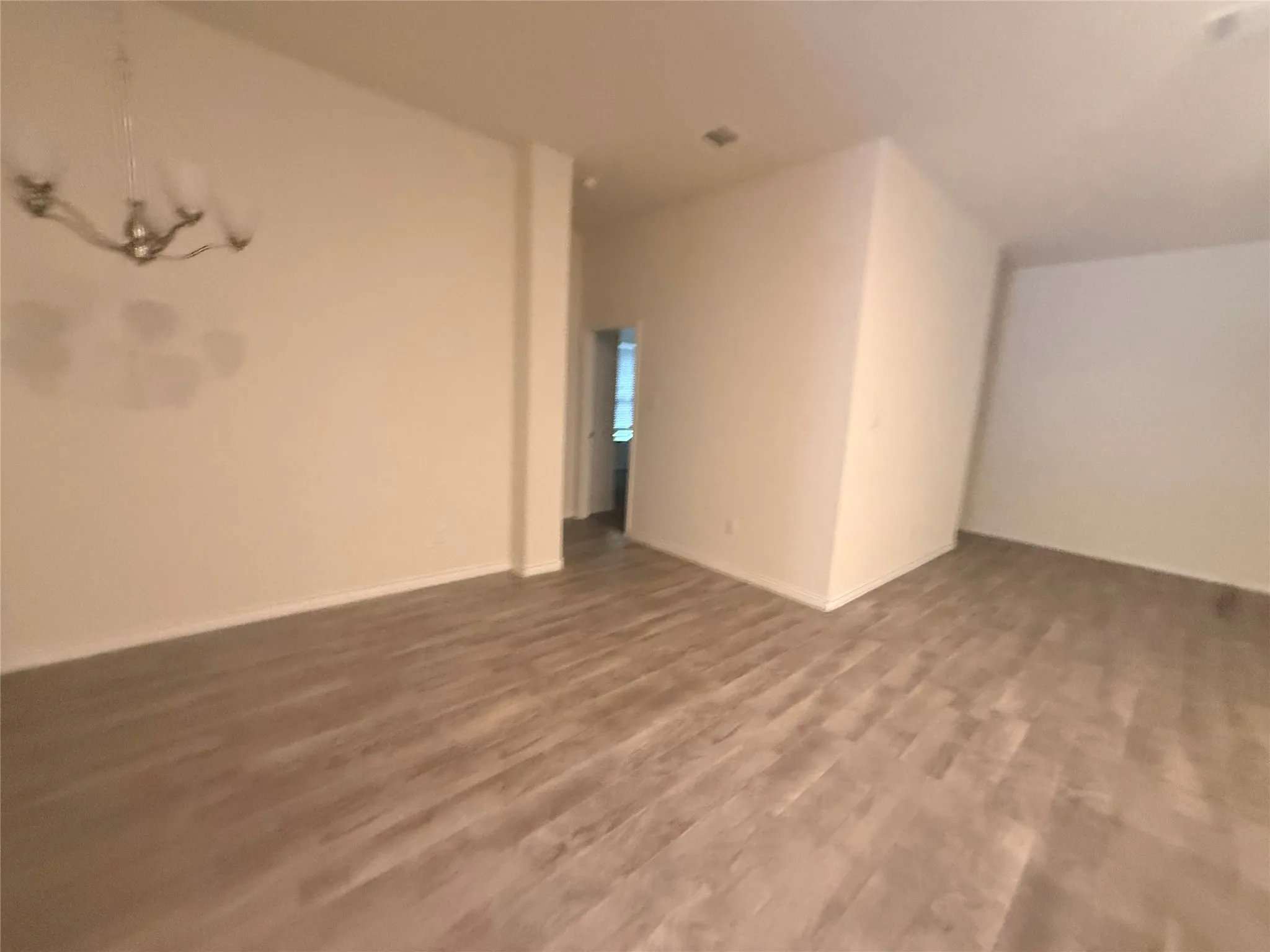 Recessed lighting, wood-finish flooring, and a chandelier fixture