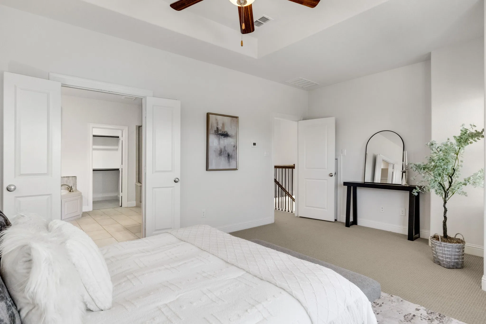 Carpeted room with high ceilings, a ceiling fan, and white interior doors