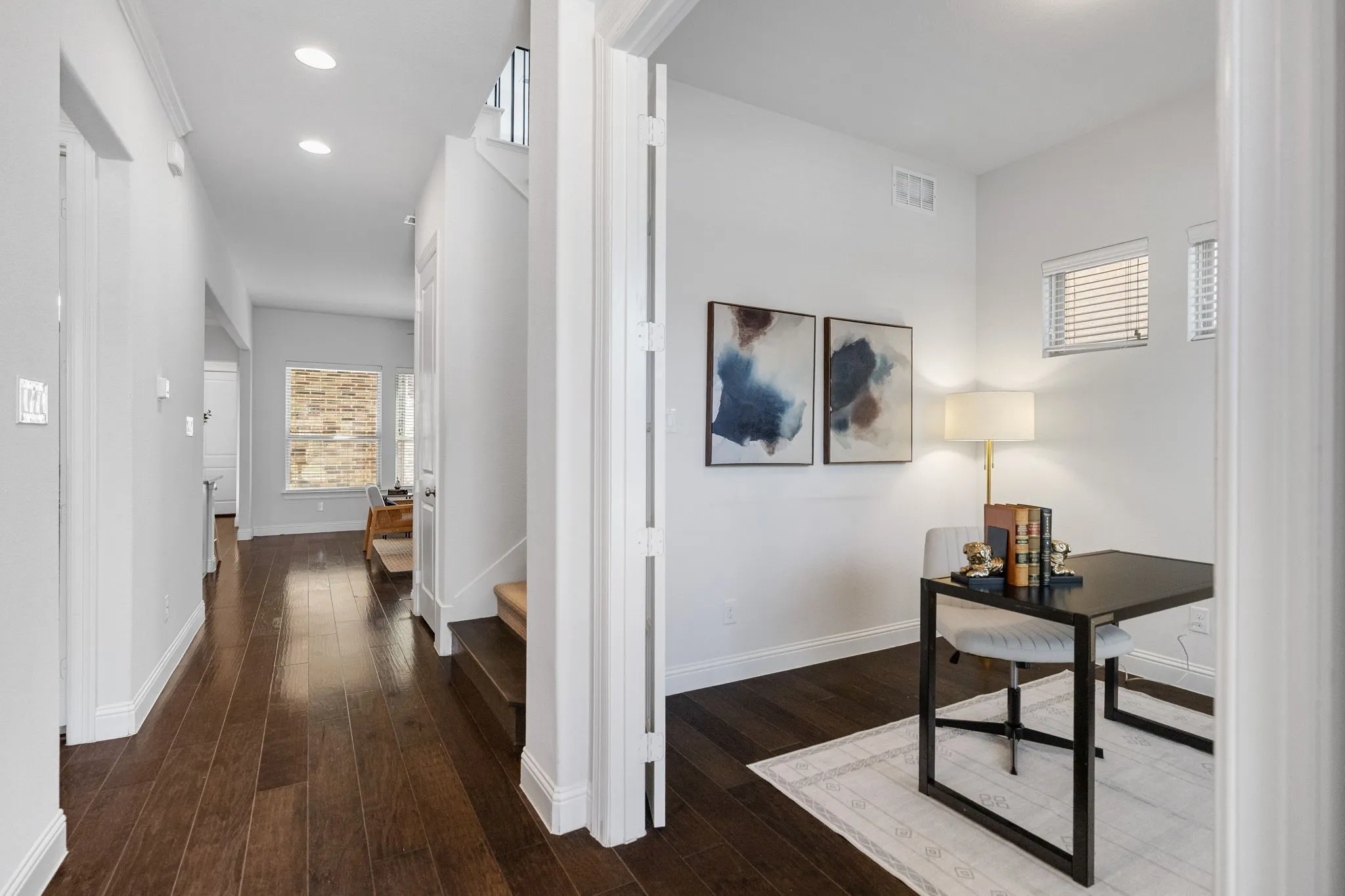 Wood-finish flooring throughout, recessed lighting, and white trim