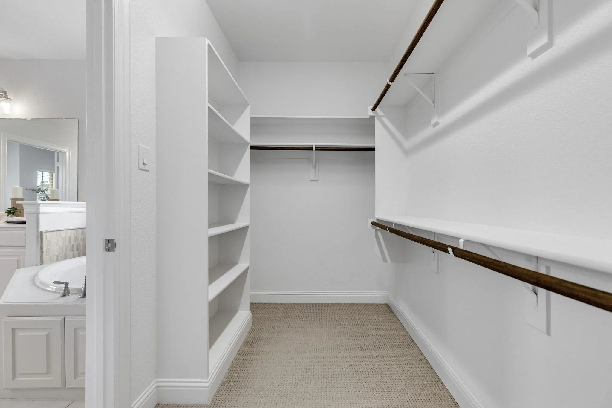 Built-in shelving, multiple hanging rods, and ample storage space
